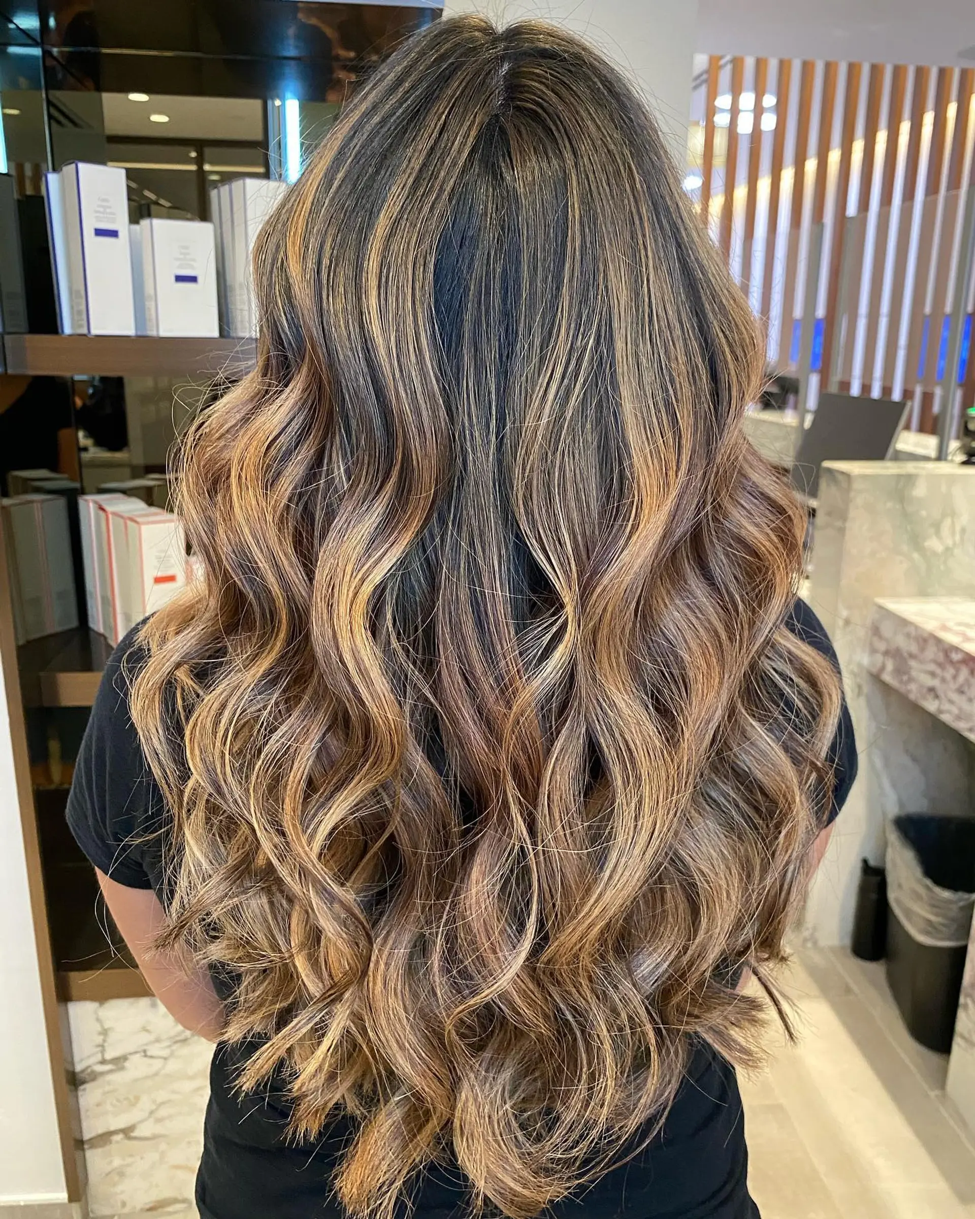 Long, layered hair with soft waves and a blended balayage color melt. 1