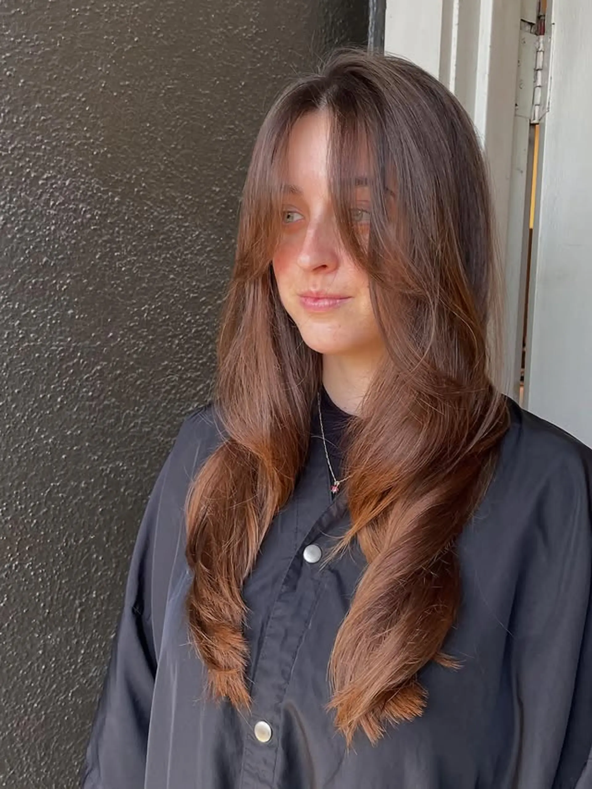 Long wavy hair with curtain bangs and face-framing layers. 1