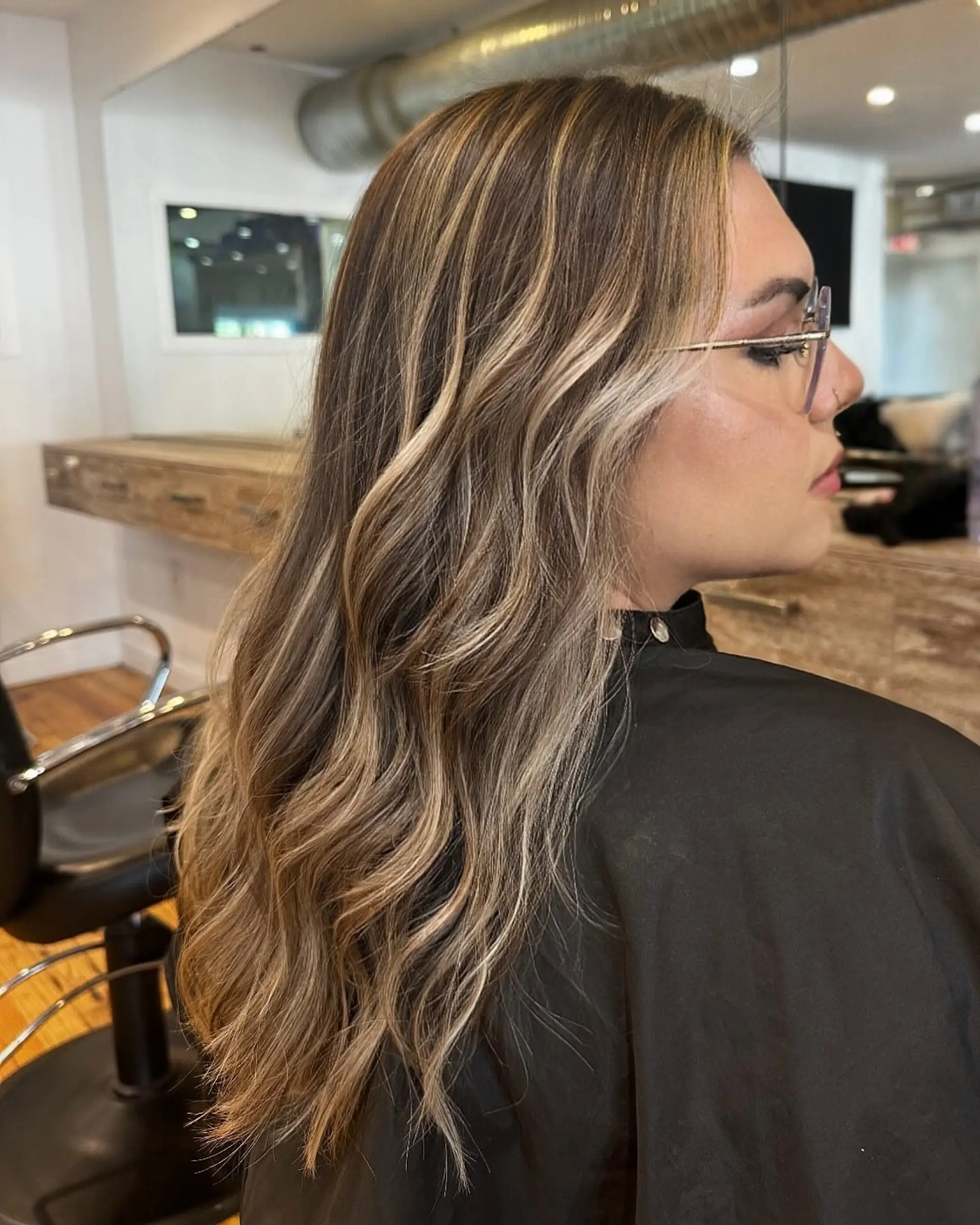 Long wavy hair with a blonde balayage. 1