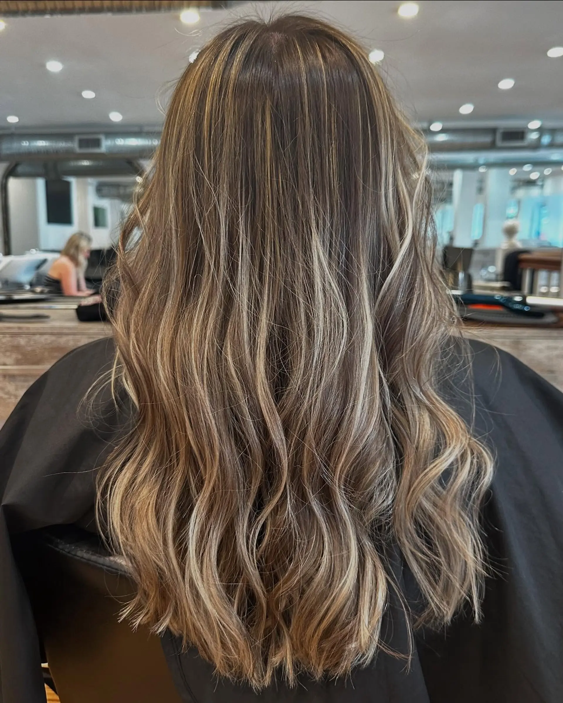 Long wavy hair with a blonde balayage. 2