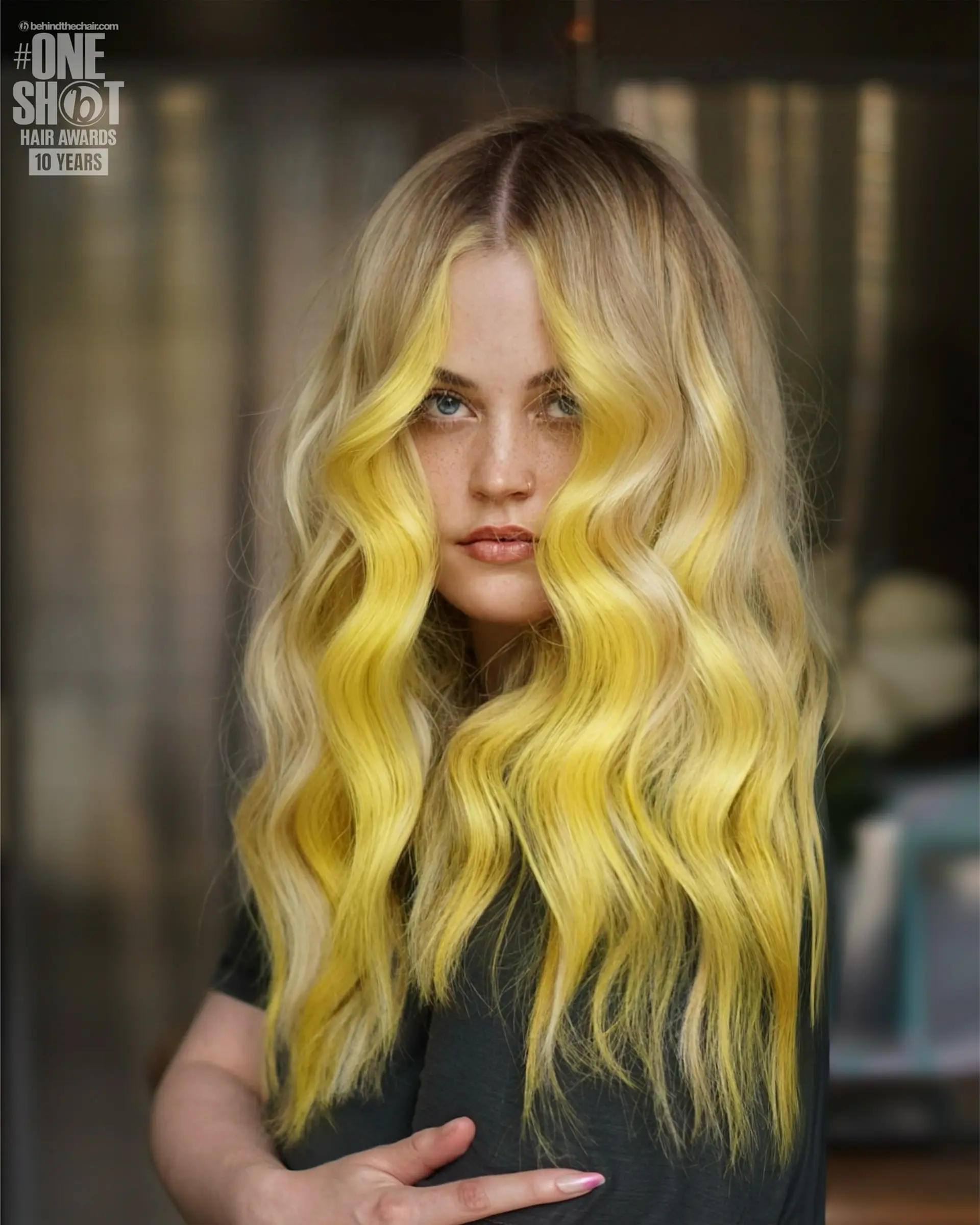 Long wavy blonde hair accented with a bold, bright yellow face-framing money piece parted down the center. 1