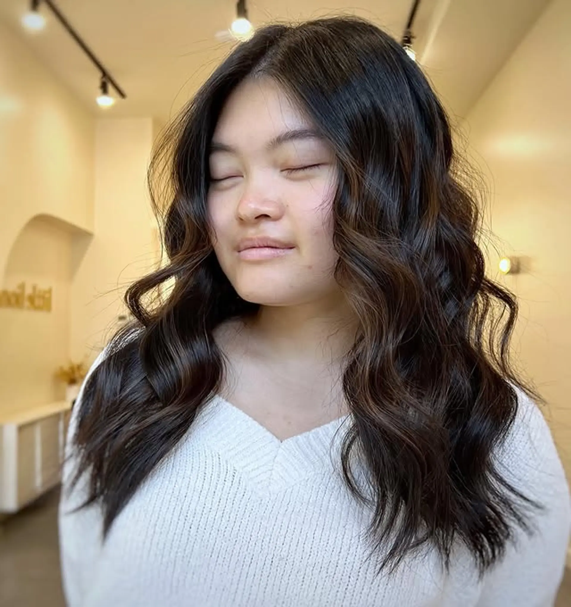 A stunning medium-length wavy hairstyle with lived-in brunette tones. 1