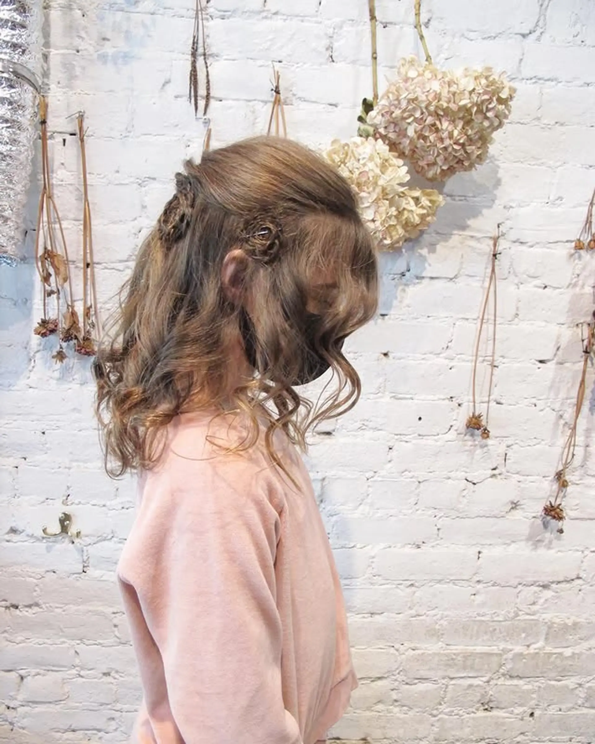 A romantic half-updo featuring loose, flowing curls. 1