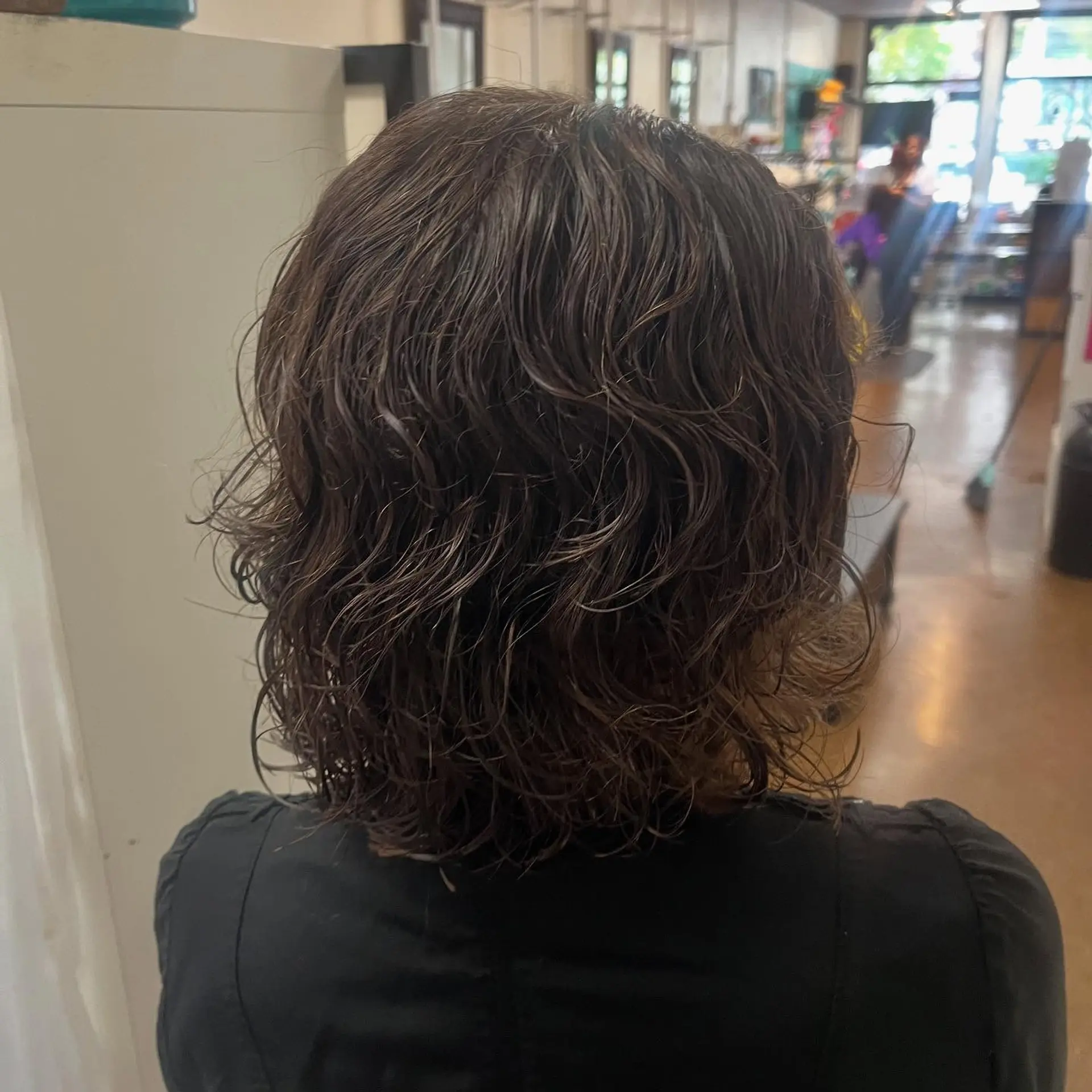 A short-to-medium textured layered haircut cut to enhance natural wave and movement. 1