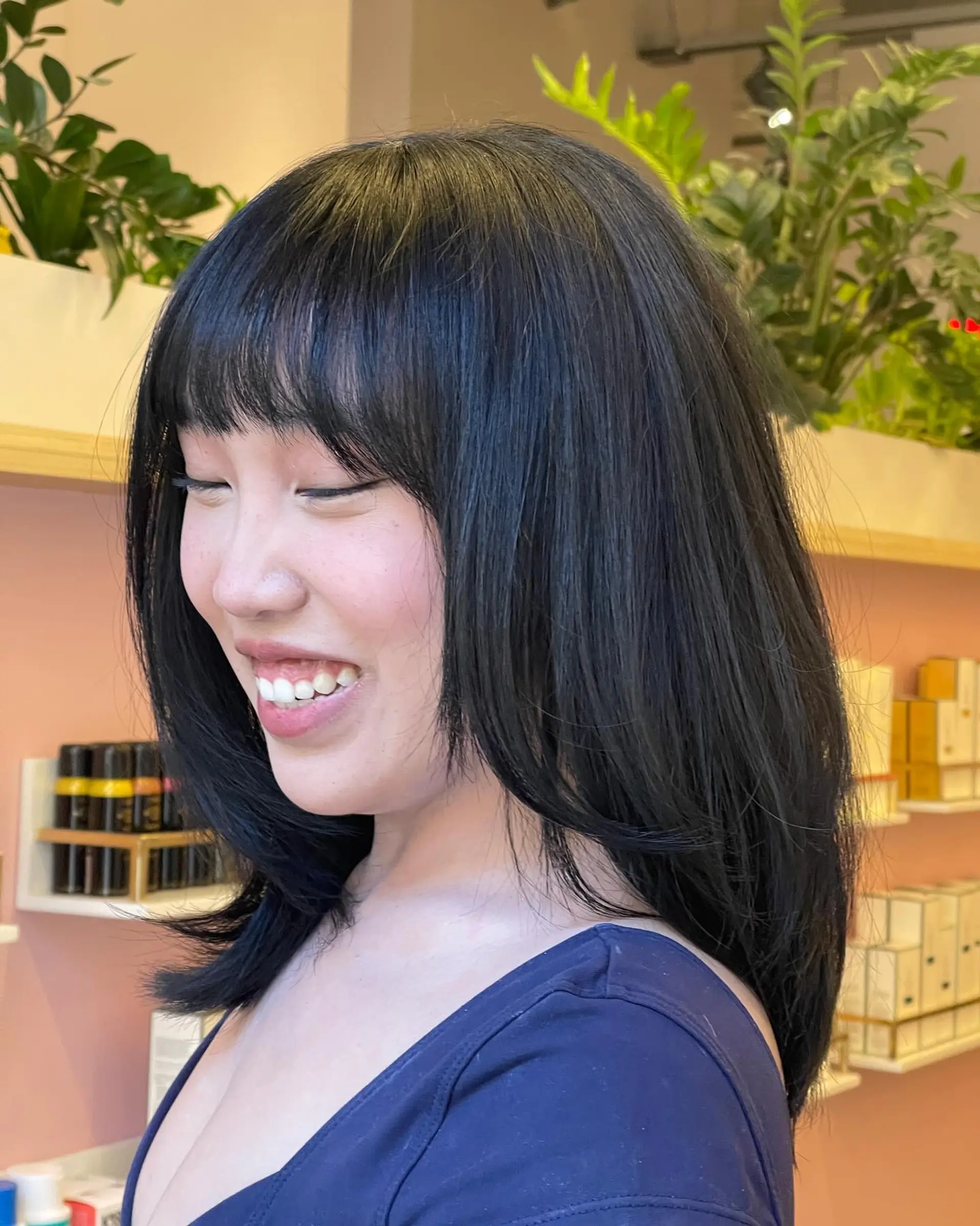Medium-length glossy black hair featuring textured face-framing layers and a straight-across full fringe. 1