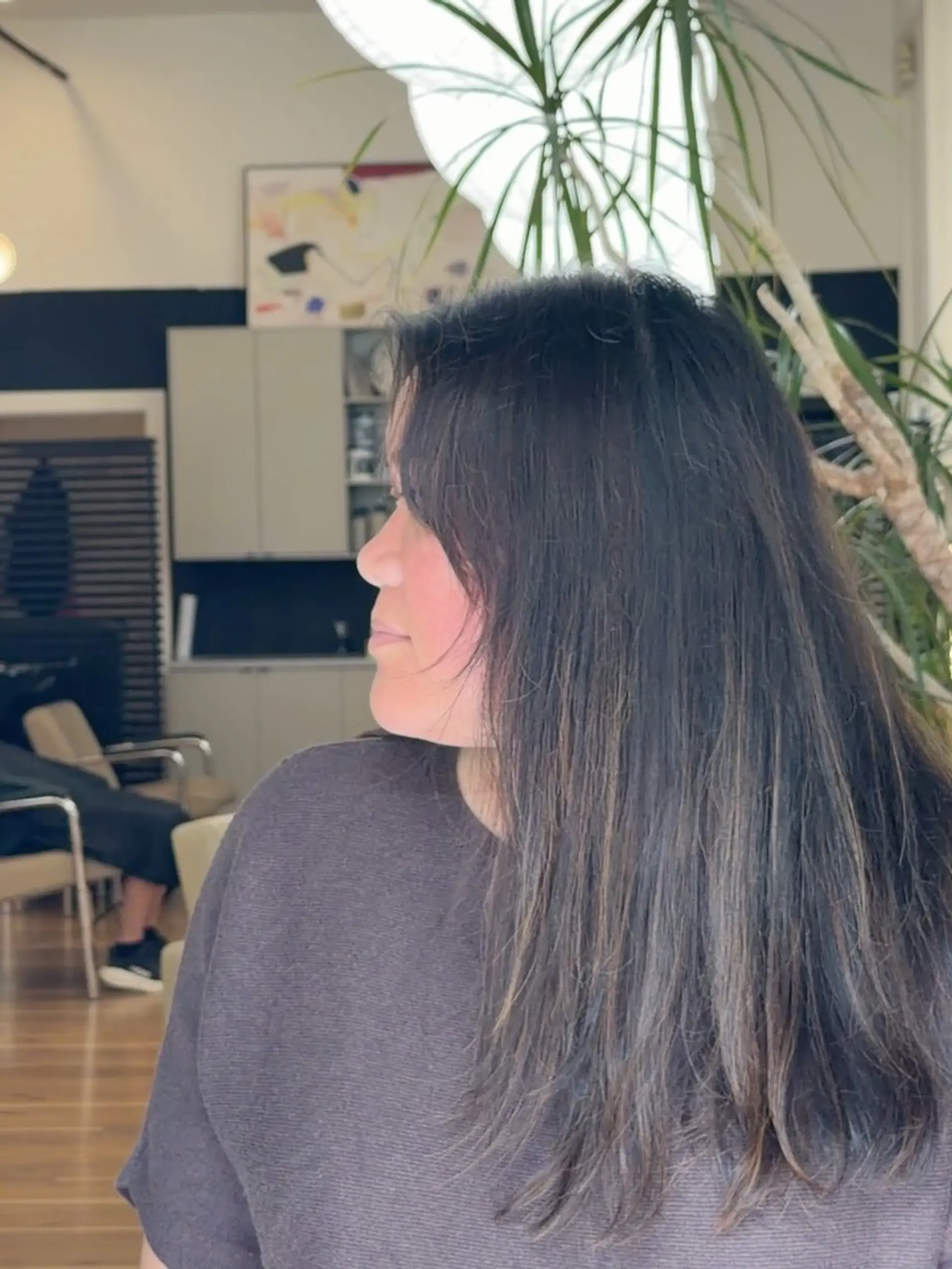 Long dark brunette hair styled with natural texture and subtle face-framing layers. 1