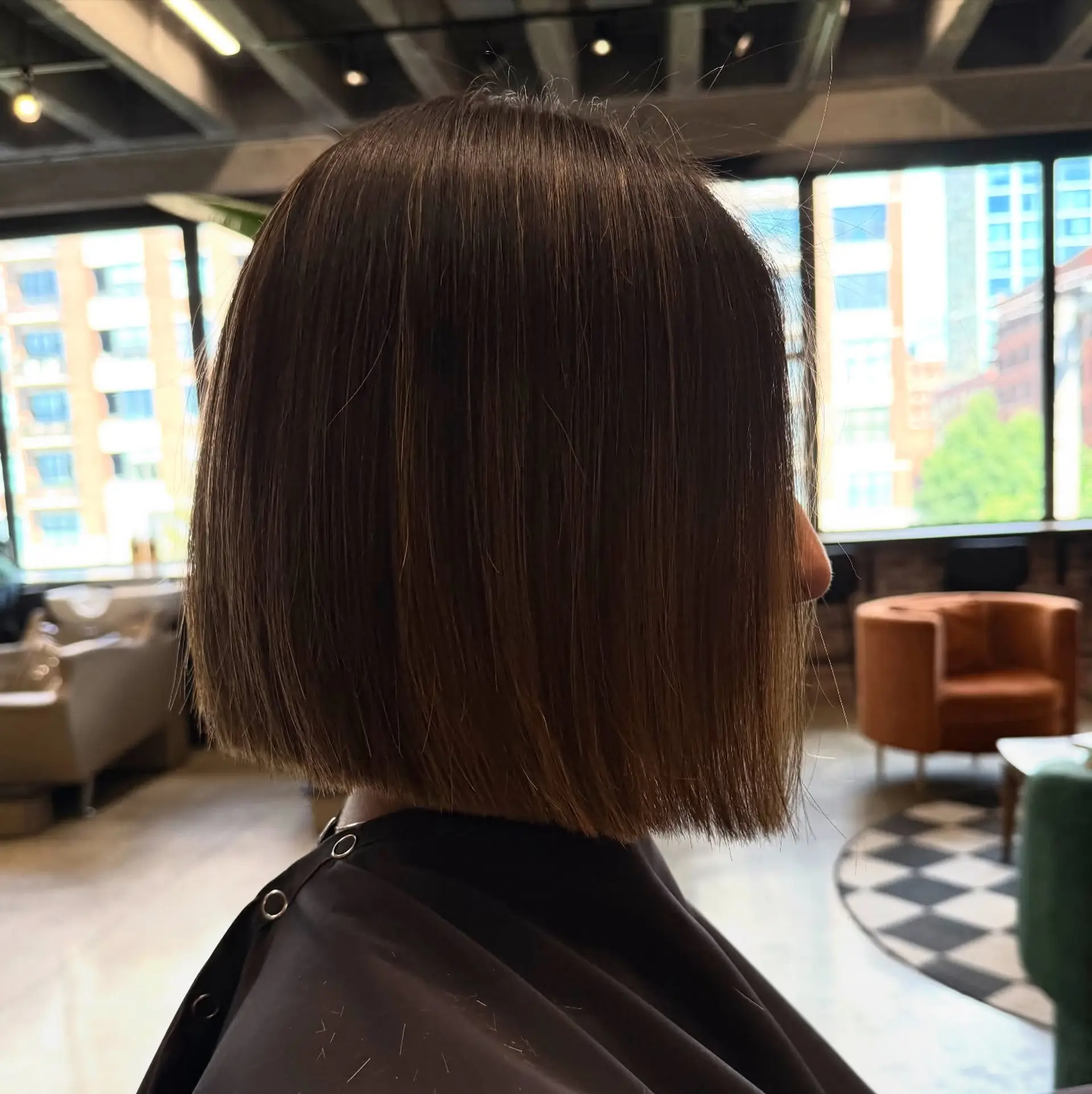 A sleek and stylish blunt bob that sits at a medium length, offering a clean and sophisticated look. 1
