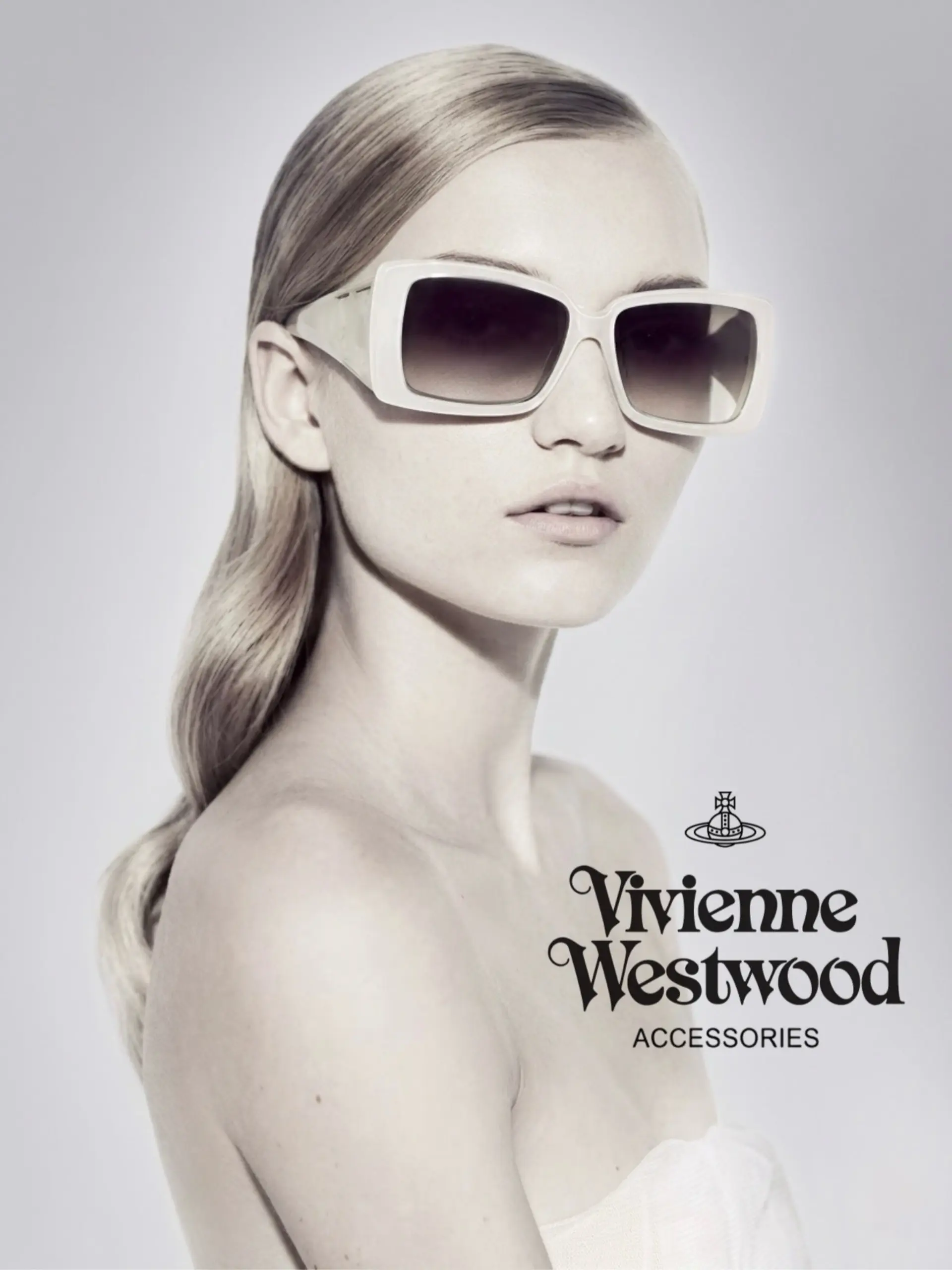 Sleek light blonde hair styled with a deep side part and soft, polished waves tucked behind the ear. 1