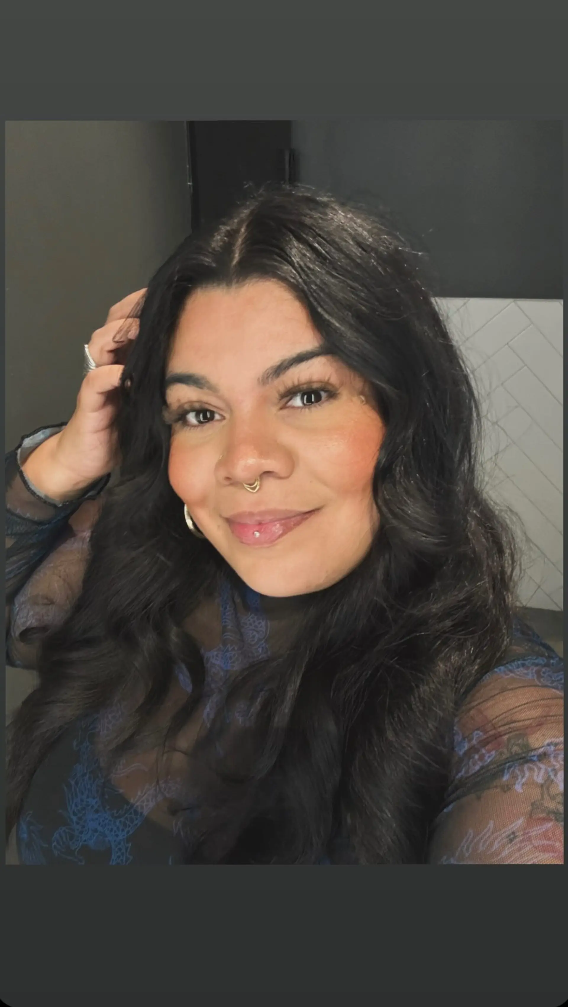 Long dark brown hair styled in soft, glamorous waves with a center part. 1