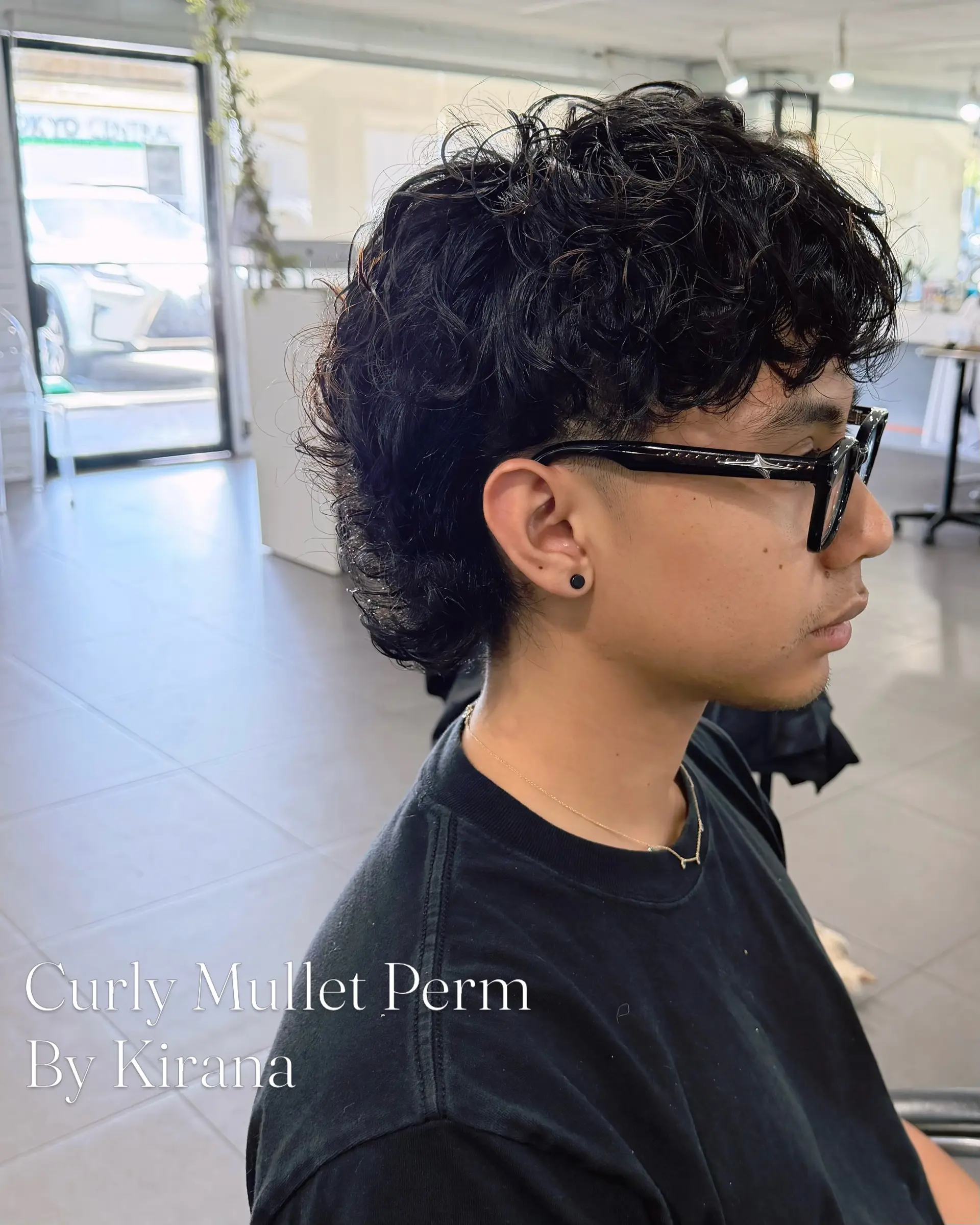 A modern curly mullet perm featuring defined, dimensional curls with volume on top and length at the nape, paired with neat shorter sides. 1