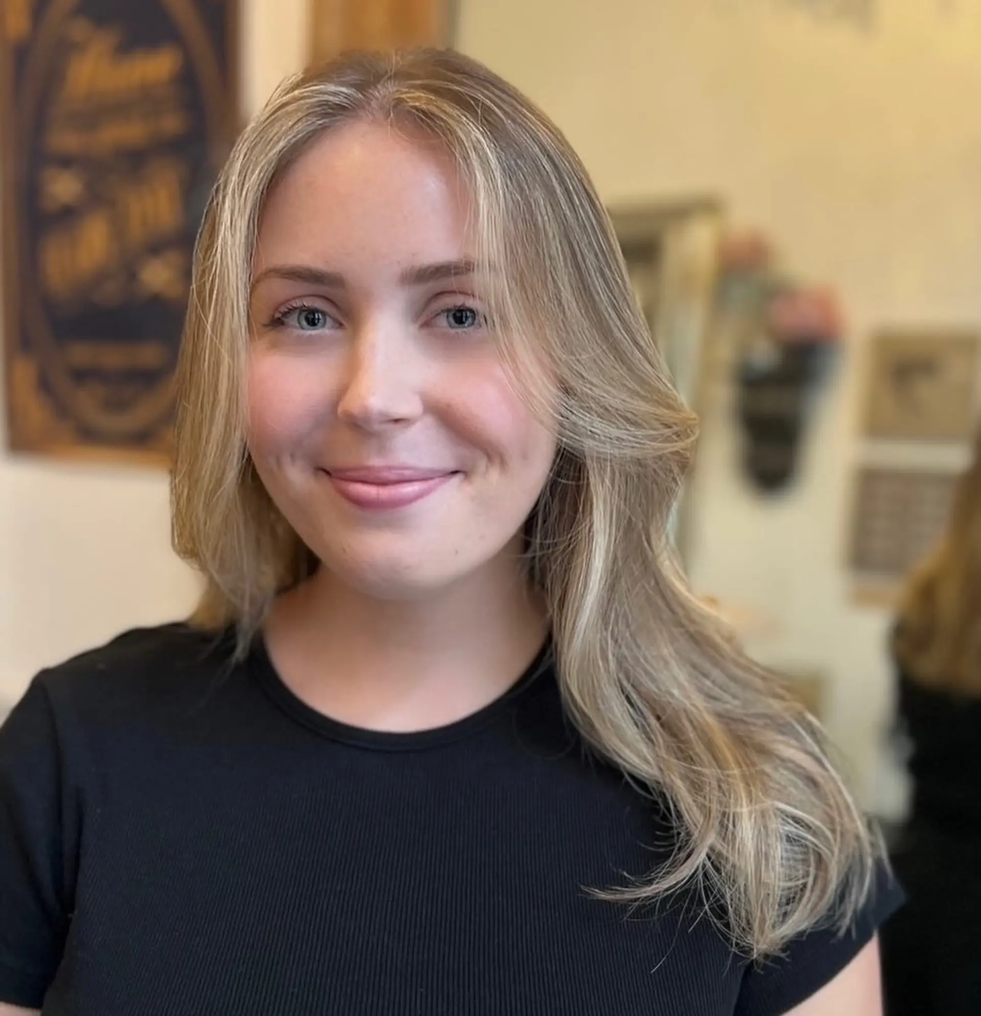 Long, wavy blonde hair with layers and a natural flow, featuring soft waves and warm honey tones. 4