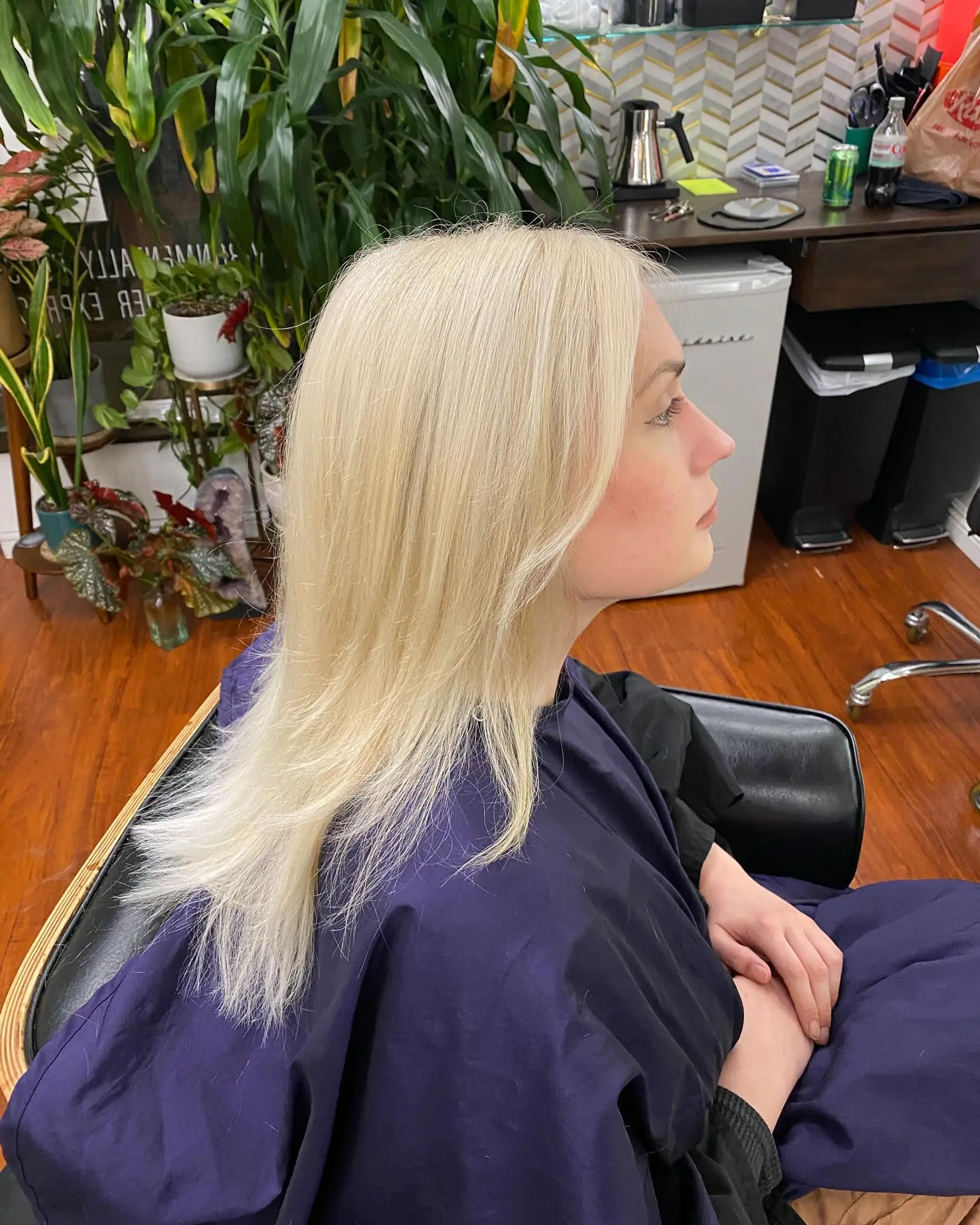 Long, sleek platinum blonde hair styled straight with smooth ends. 1
