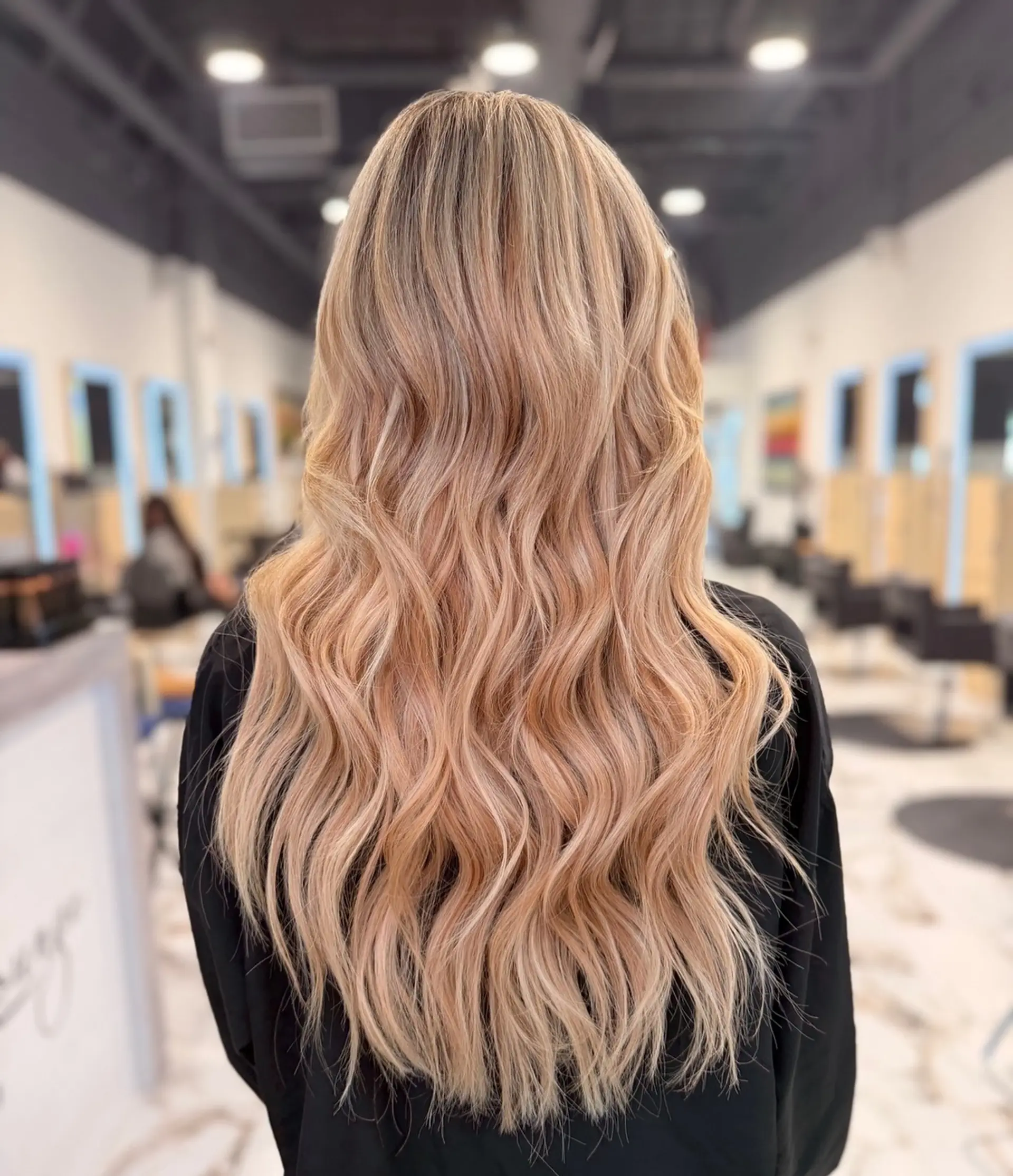 Extra-long dimensional blonde hair styled in soft, loose waves with seamless weft extensions. 1