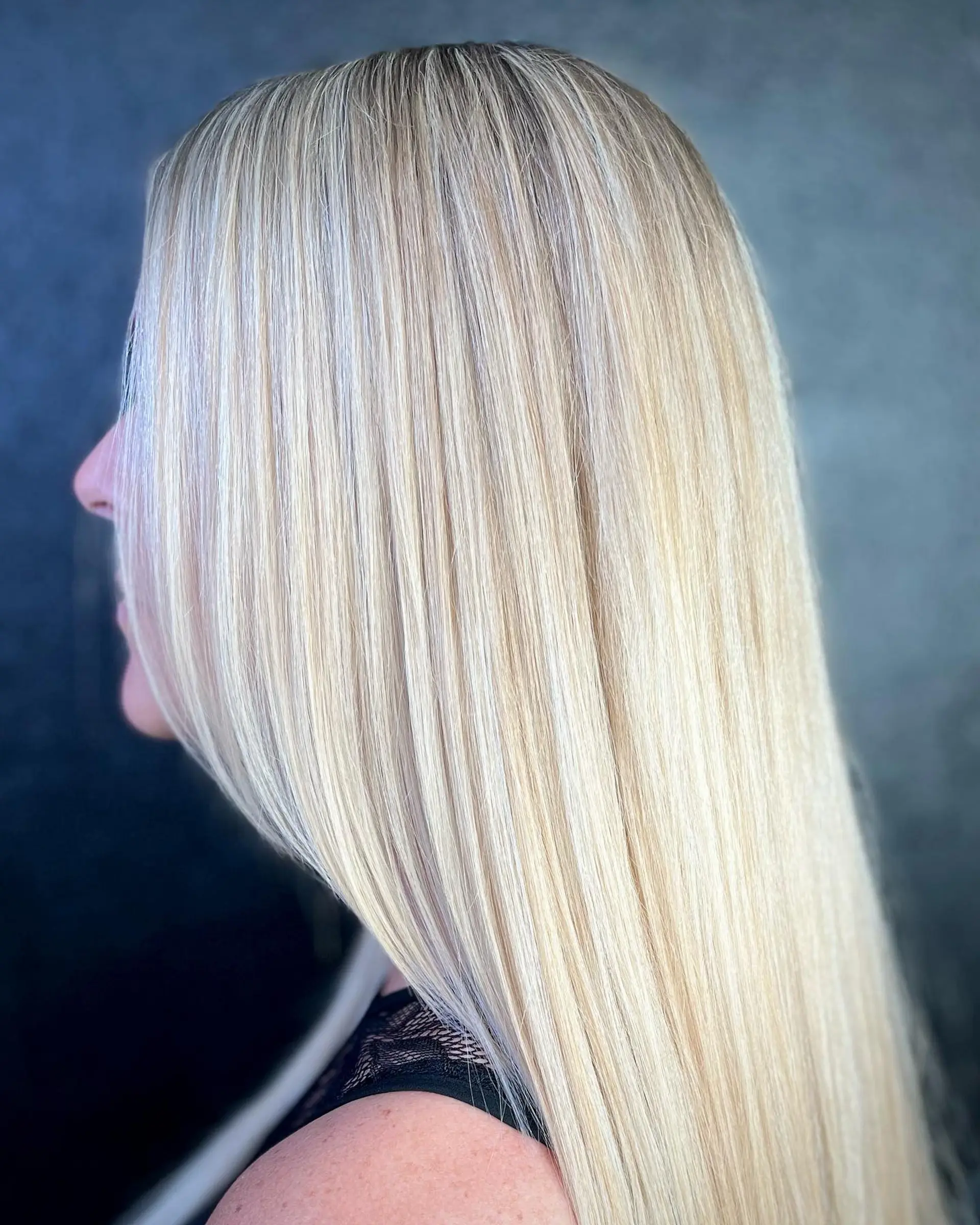 A sleek, straight, long hairstyle in platinum blonde. 1