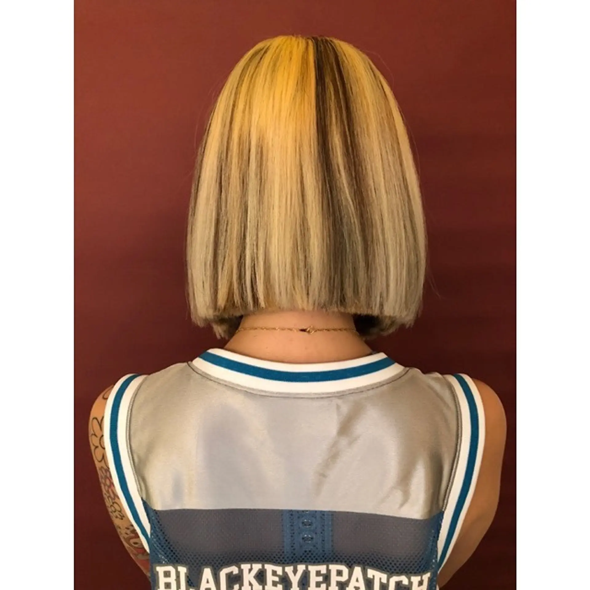 A medium-length, blunt bob with contrasting blonde and dark brown sections. 1