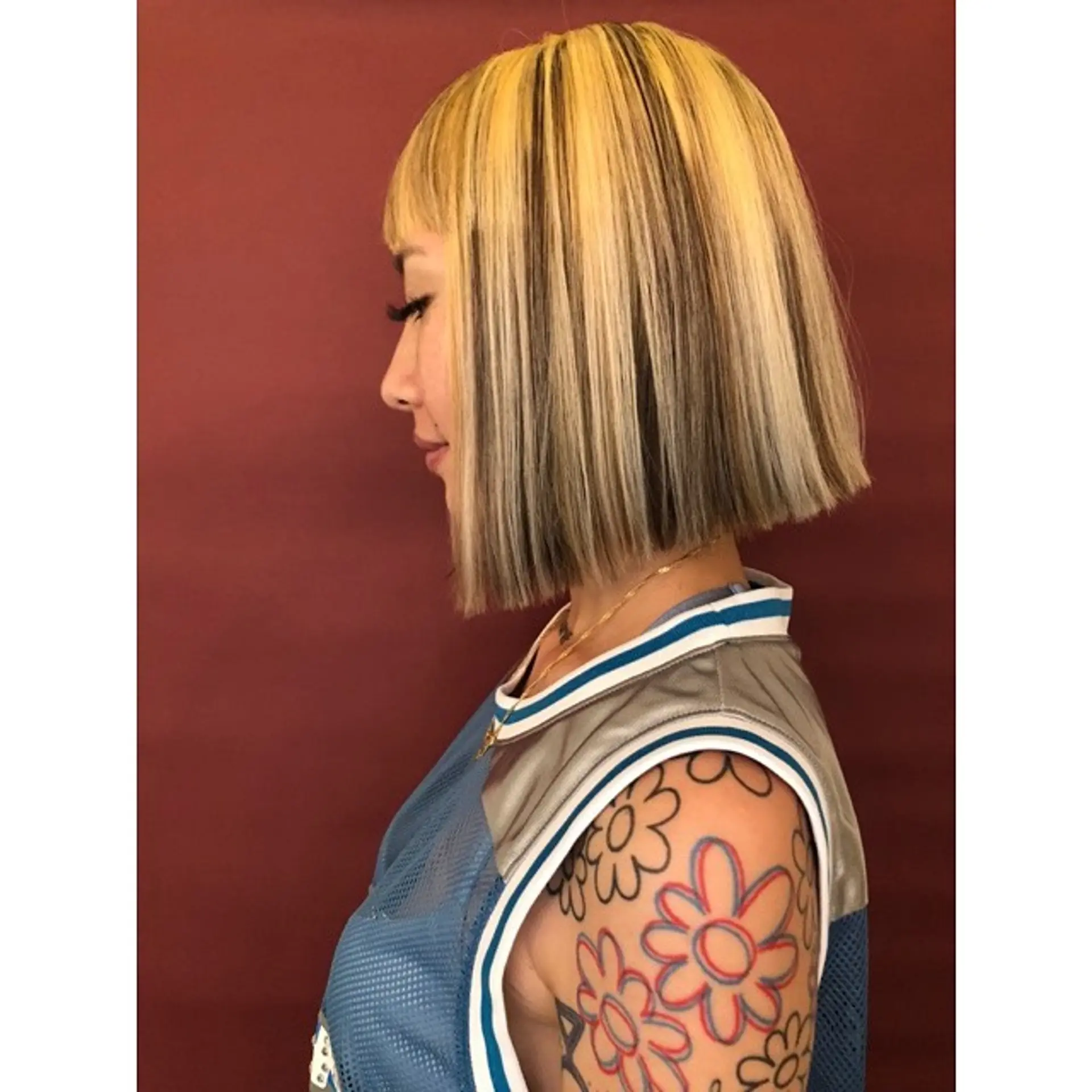 A medium-length, blunt bob with contrasting blonde and dark brown sections. 3