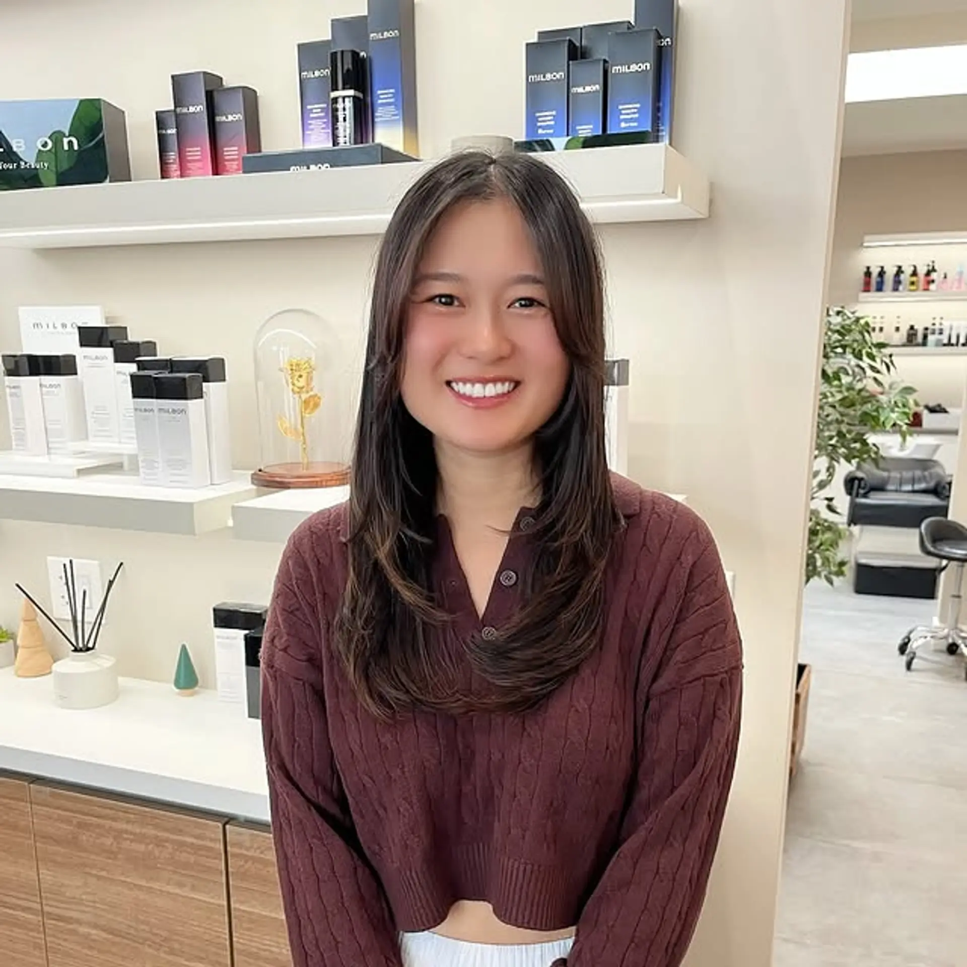 A long, layered hairstyle with face-framing curtain bangs. 1