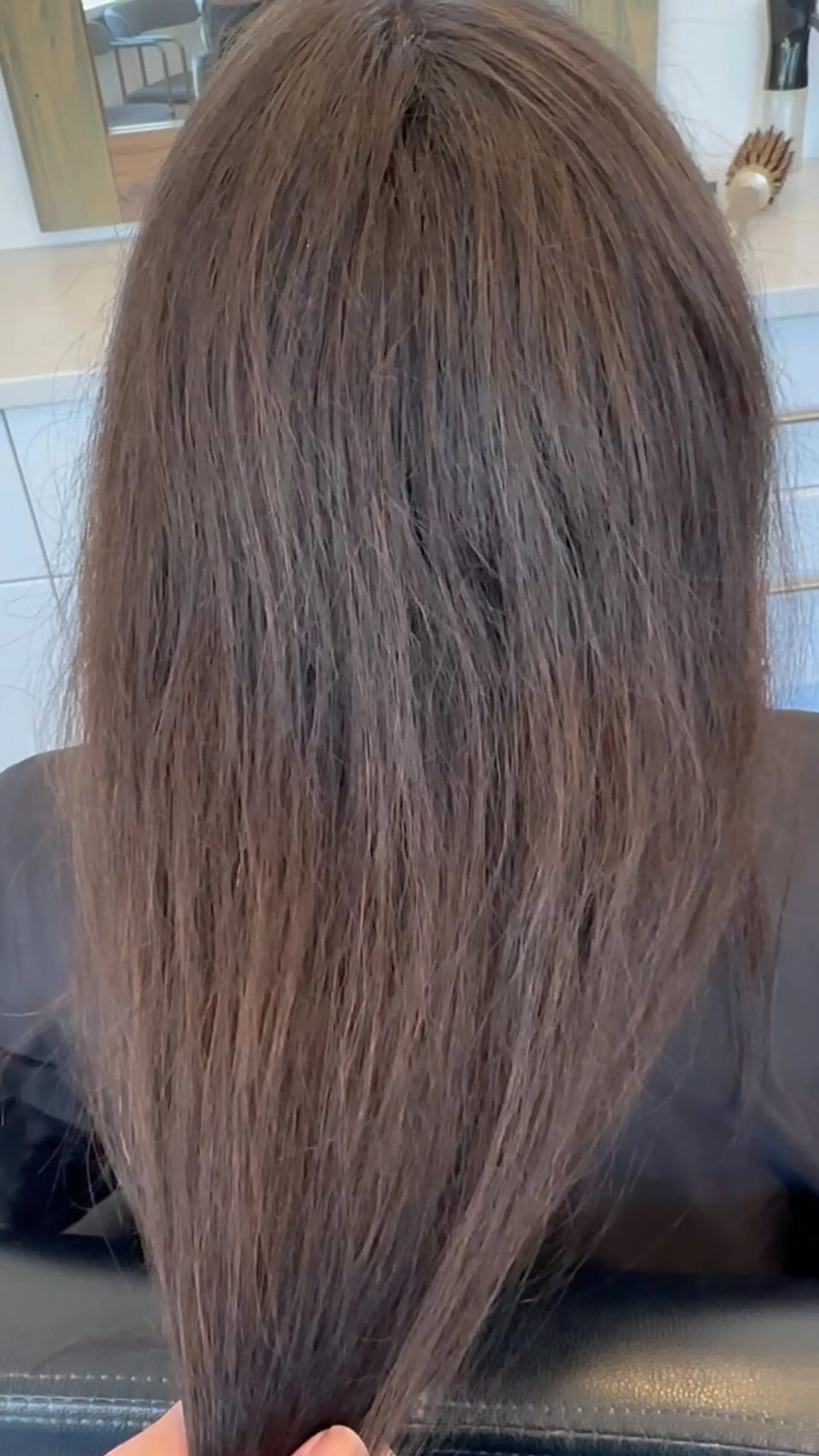 Long brunette hair seen from behind with a straight texture and subtle natural body. 1