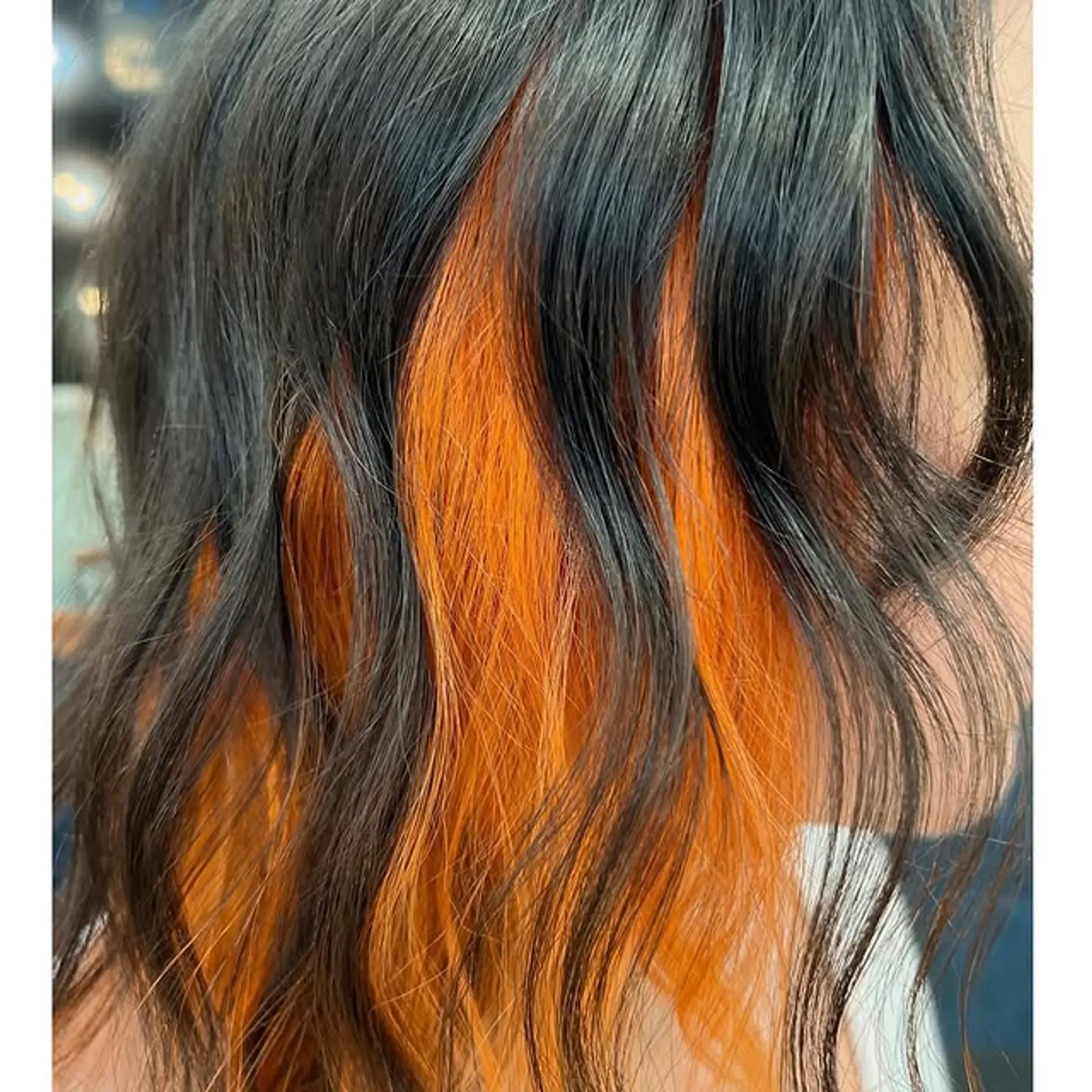 Medium wavy hair with hidden orange peekaboo highlights. 1