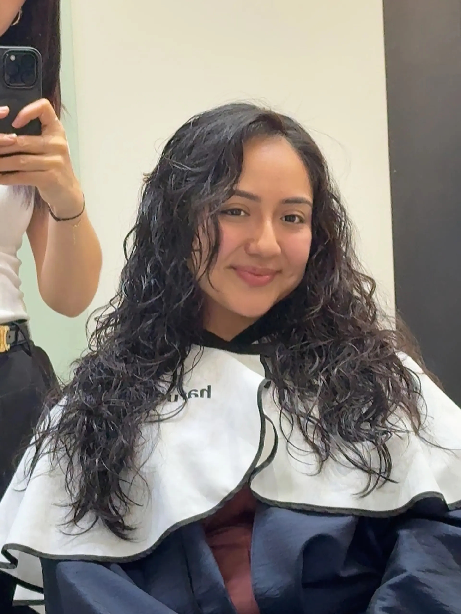 A long, layered cut designed to enhance natural curl patterns, adding movement and volume while framing the face. 1