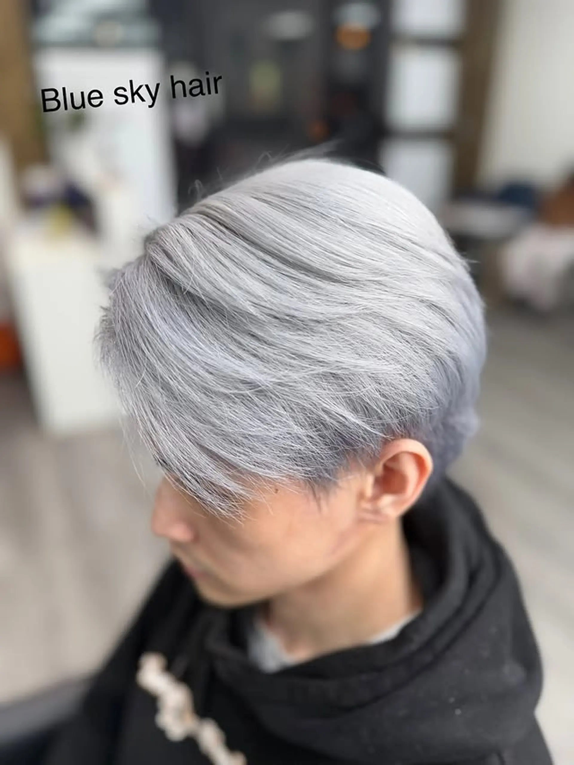 A layered short haircut with a cool-toned blue-gray color and textured styling. 1