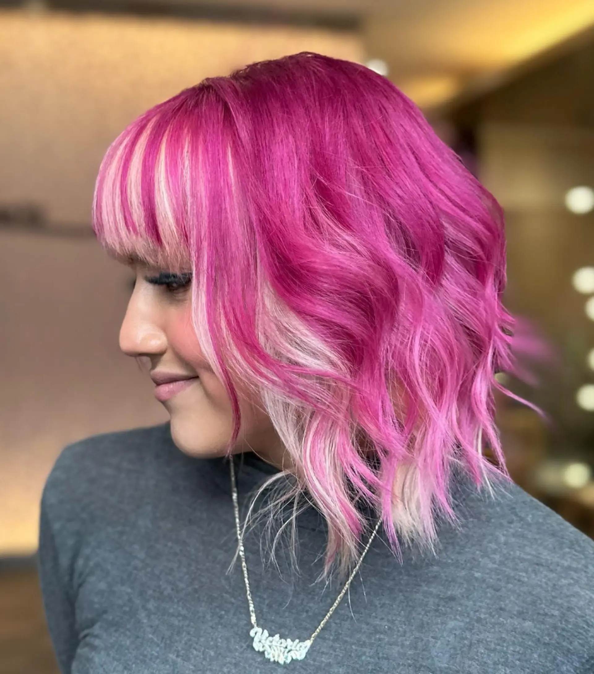 Medium-length wavy hair in magenta pink with blunt blonde bangs, featuring bold contrast and playful, edgy waves.

Color by @simabeautynyc
Cut by @juliamannino_hair
 2