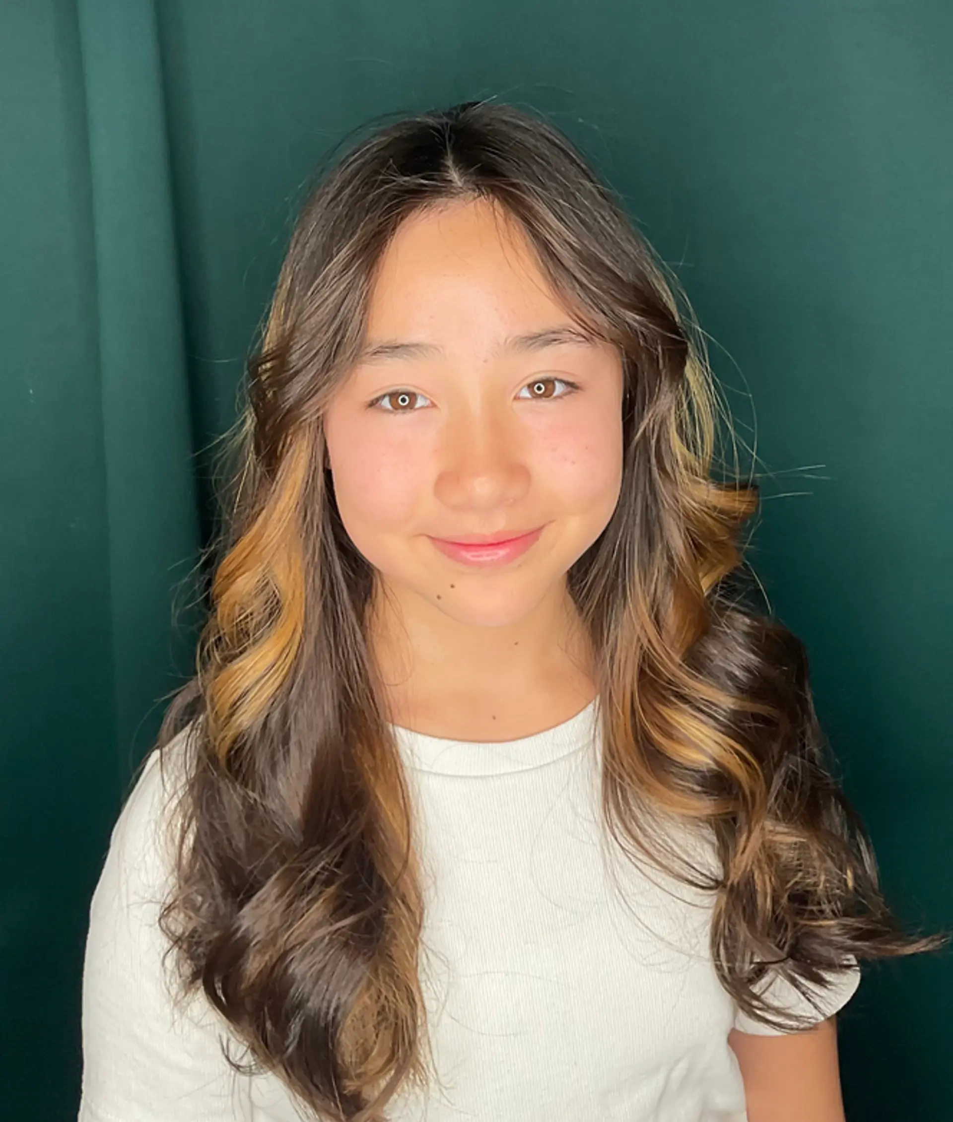 A captivating long hairstyle featuring dark brown hair with luxurious golden highlights and soft waves. 1