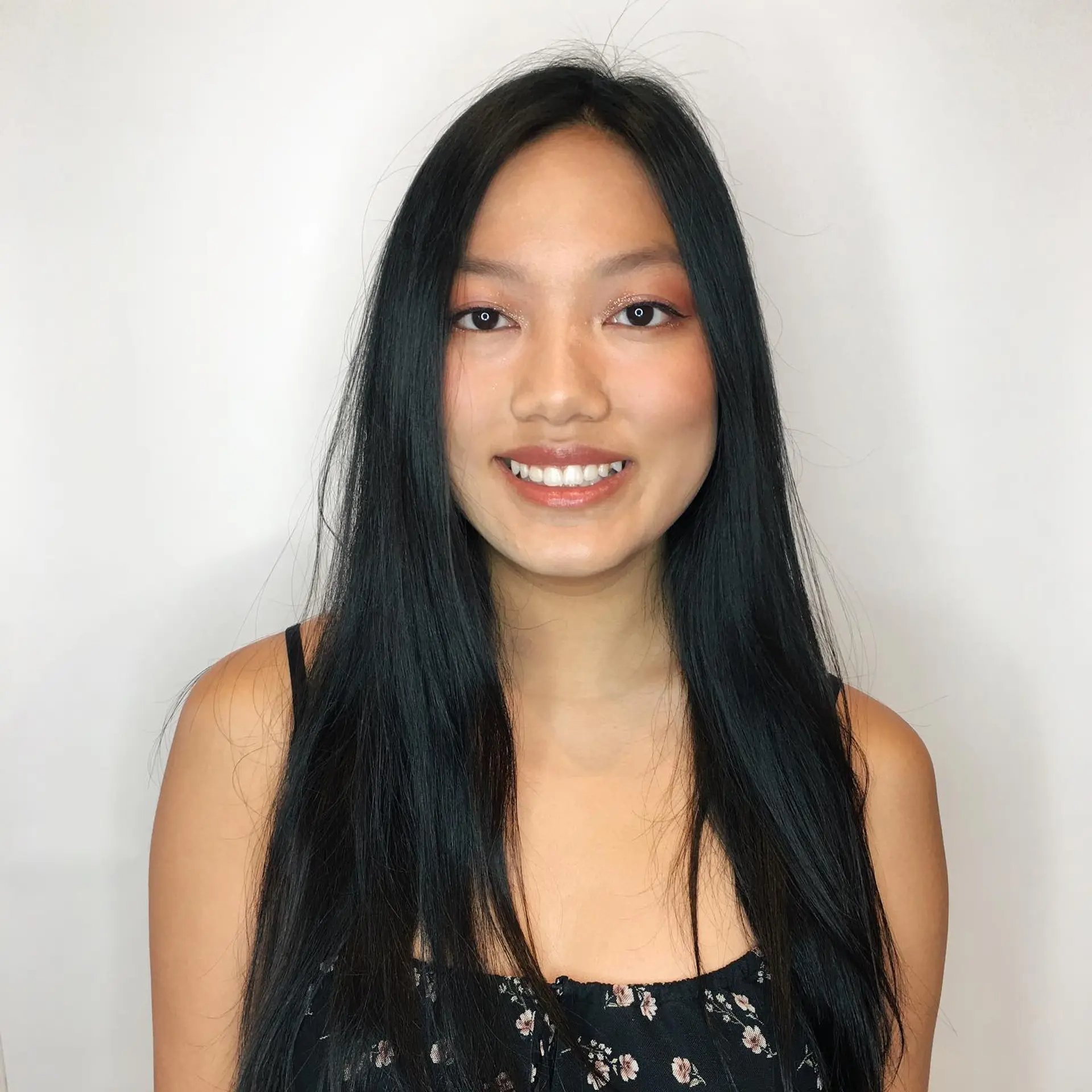 Long, straight jet-black hair with a middle part and natural texture. 1