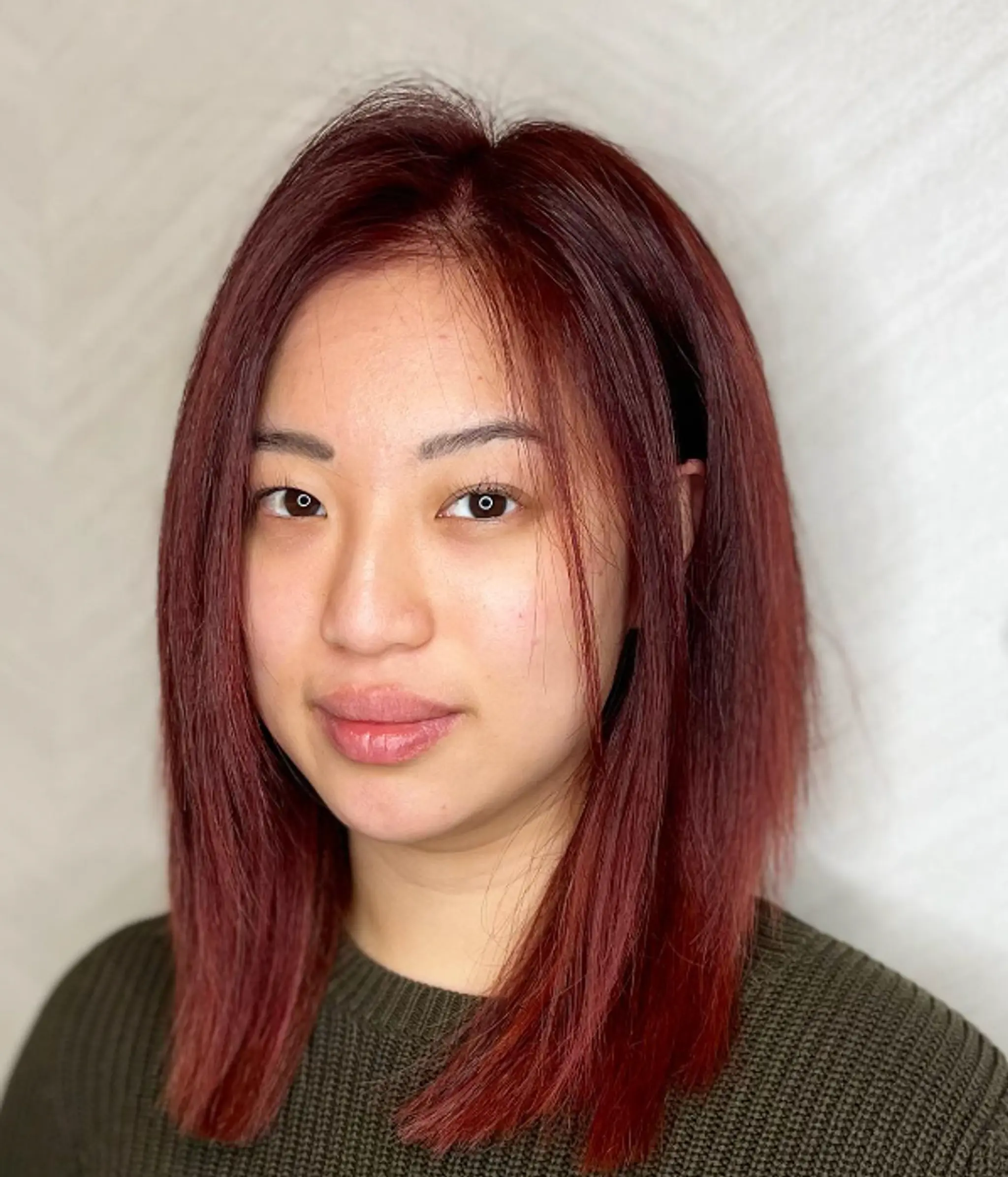 The model has medium-length, straight hair with a middle part, sleek texture, soft layers, and blunt ends, all colored in a vibrant red.

Color by @simabeautynyc
Cut and style by @juliamannino_hair
 1