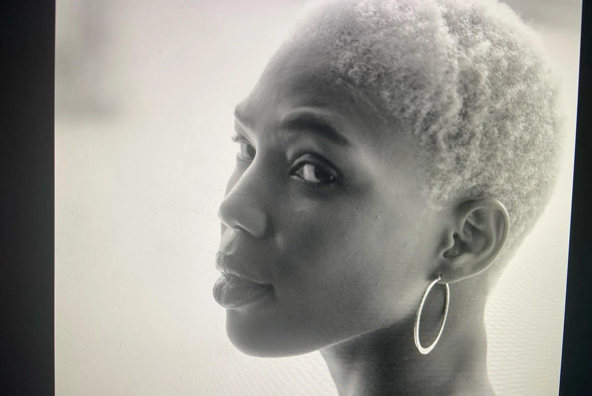 A very short buzz cut dyed in a platinum blonde. 4