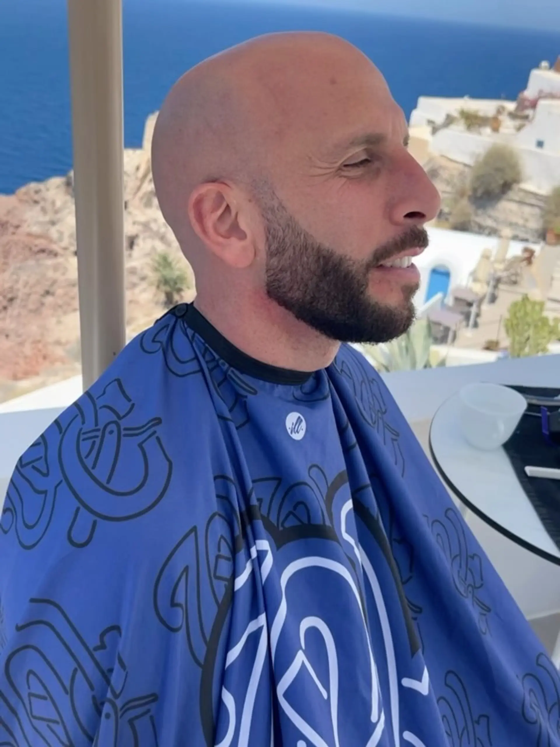 A smooth, clean-shaven bald head paired with a neatly trimmed and sculpted full beard. 1