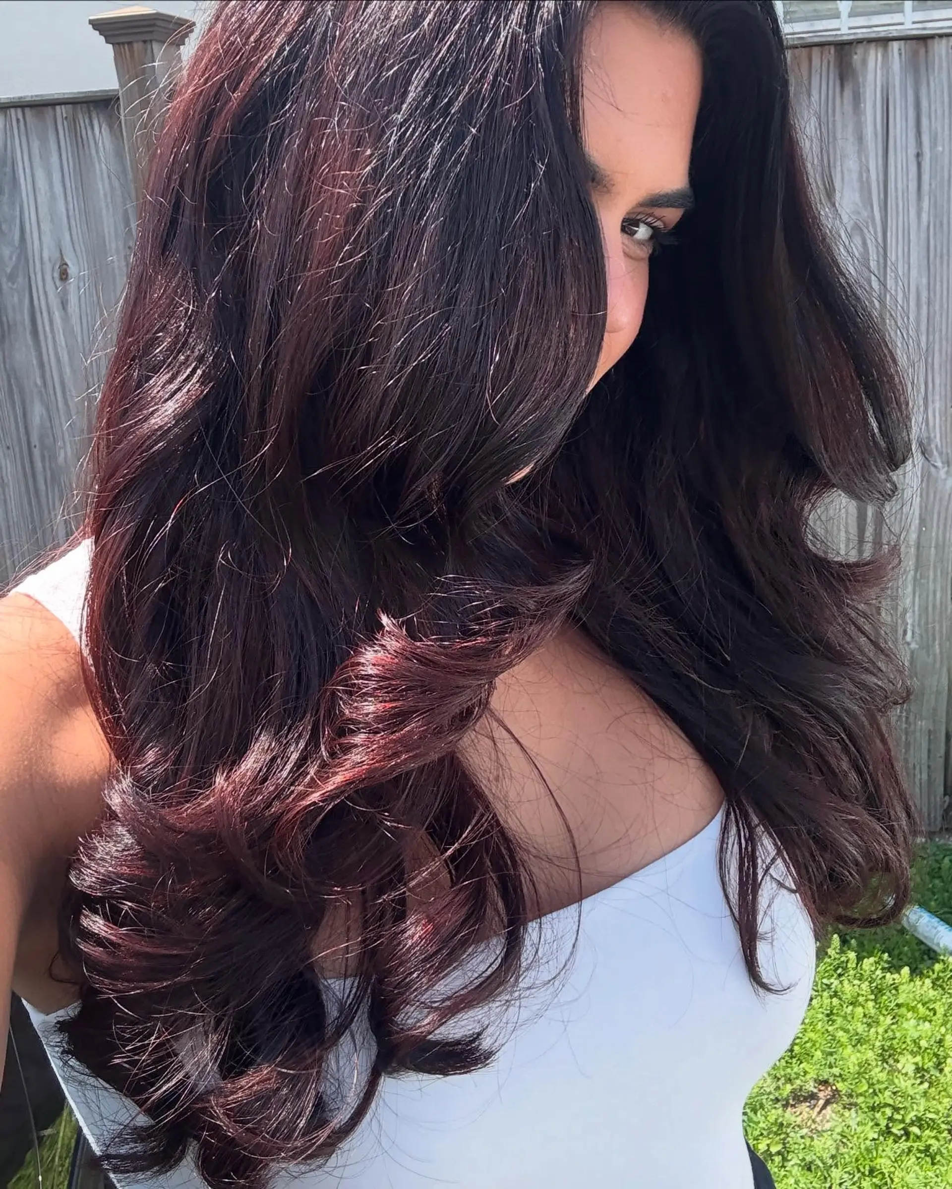 A romantic hairstyle featuring long, voluminous waves with subtle layering for added dimension and movement. 2