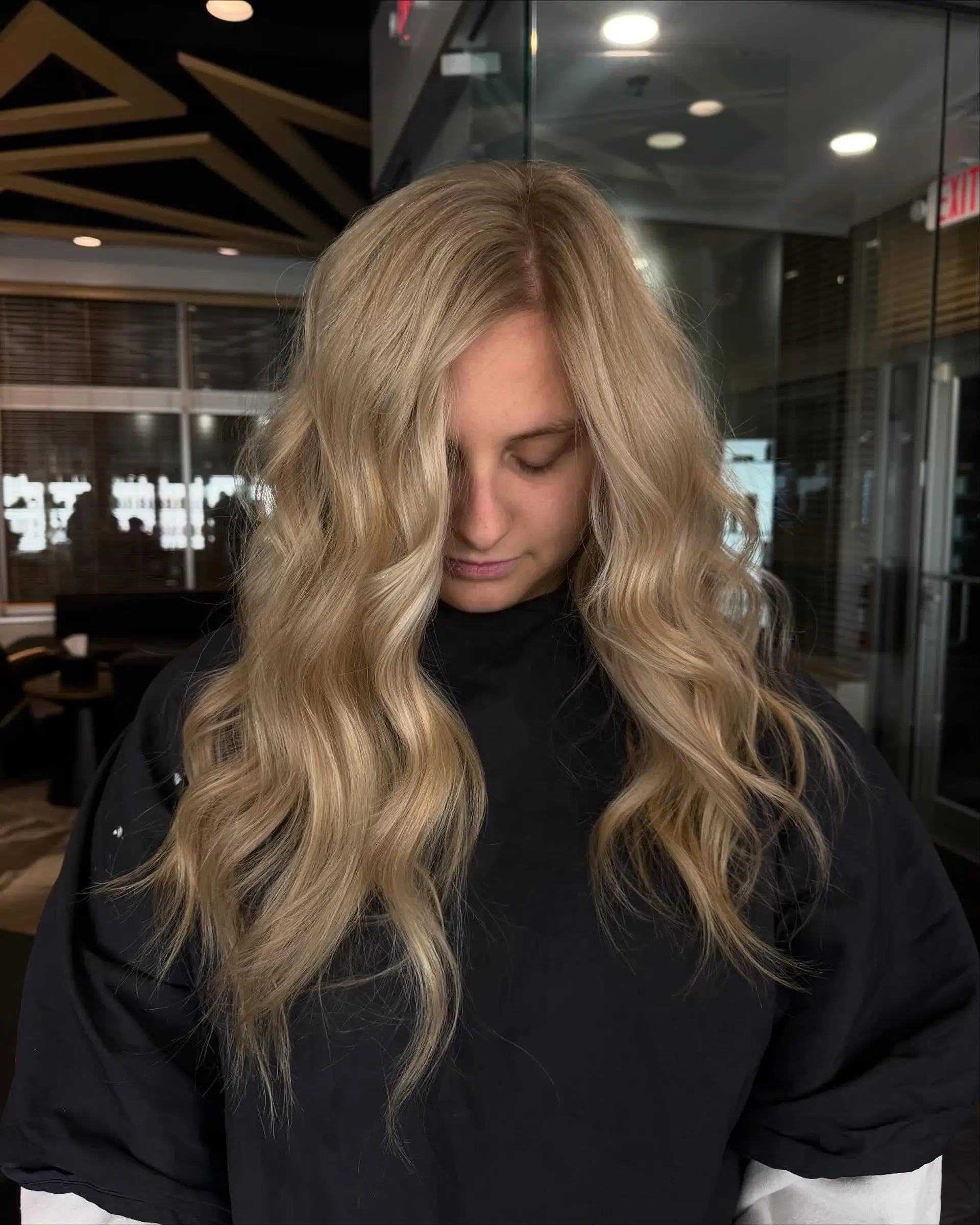 Long creamy blonde hair styled with loose, effortless waves flowing around the shoulders. 1