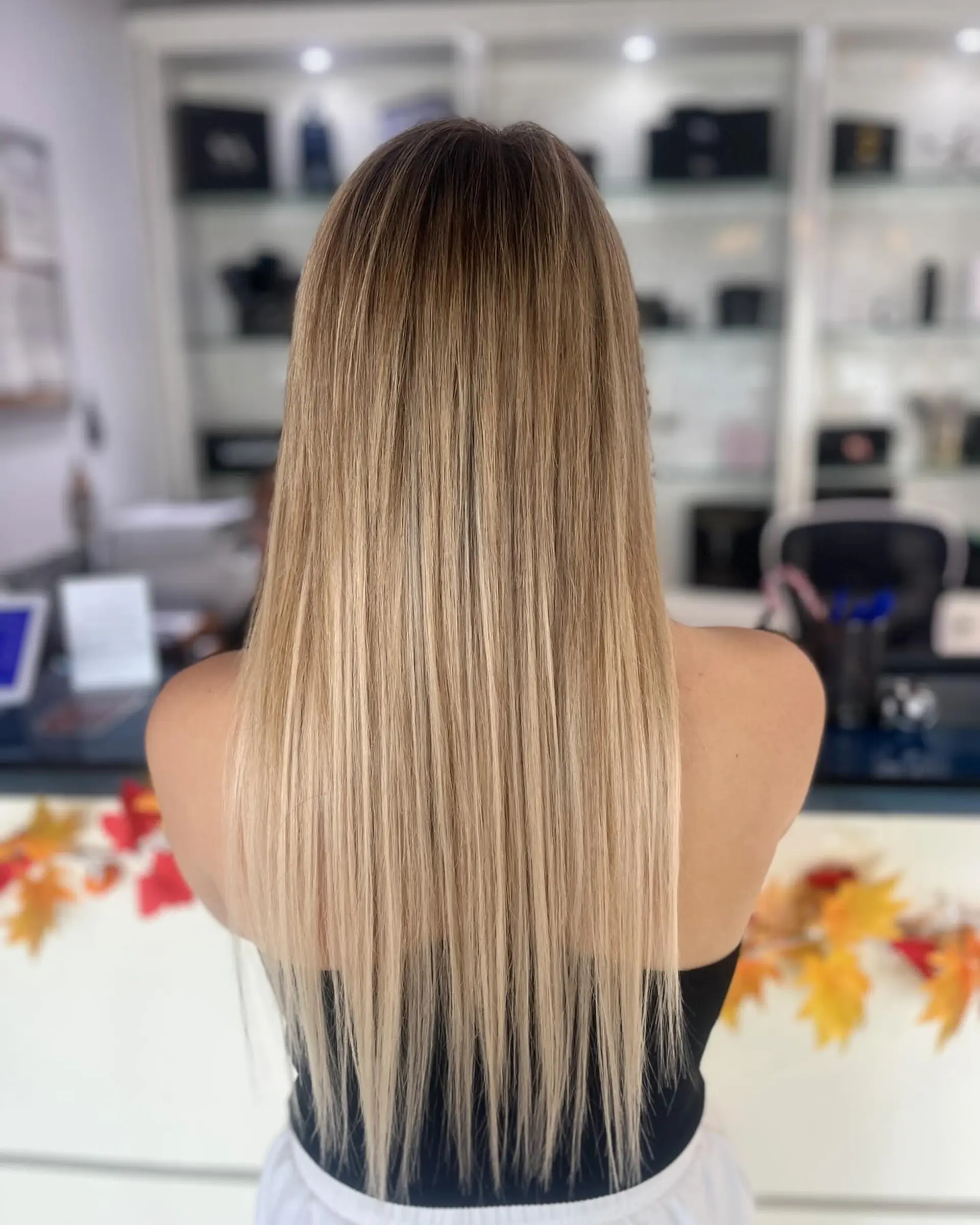 Long, straight hairstyle featuring a blonde balayage. 1