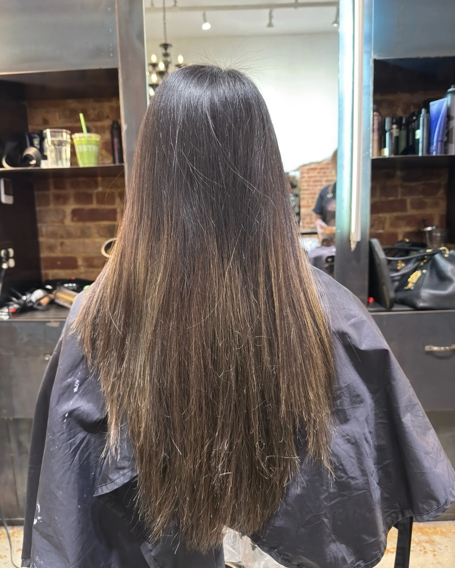 A seamless, dimensional brunette look with soft highlights. 1