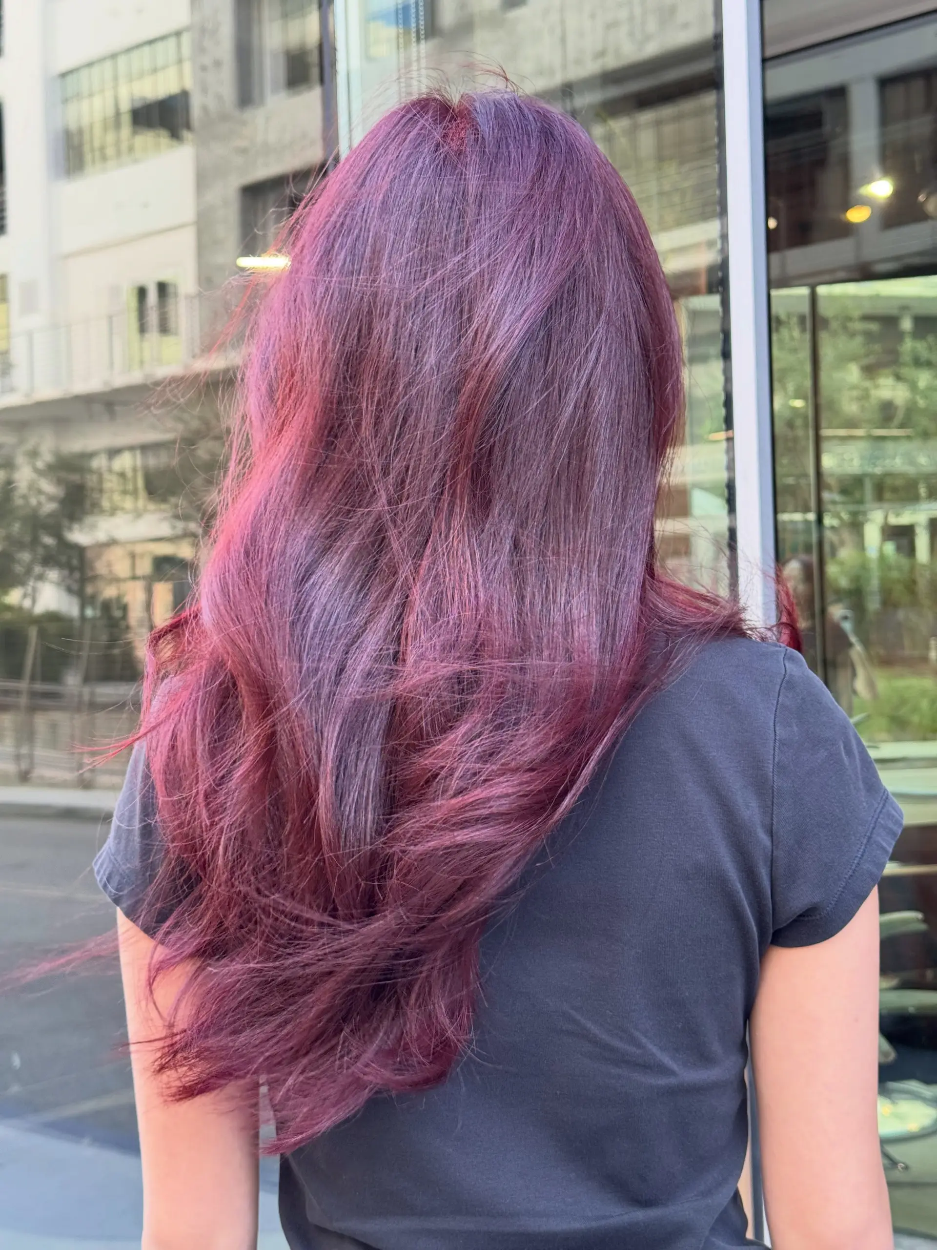 Vibrant cherry red long hair styled in a smooth, voluminous blowout with gentle movement. 1