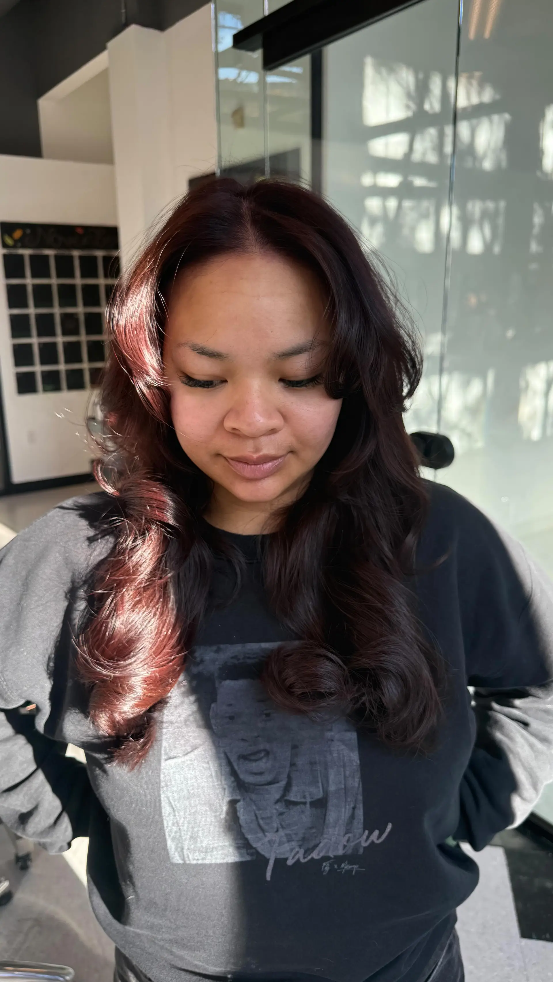 Long deep burgundy-brown hair styled into voluminous, polished curls with glossy shine. 1