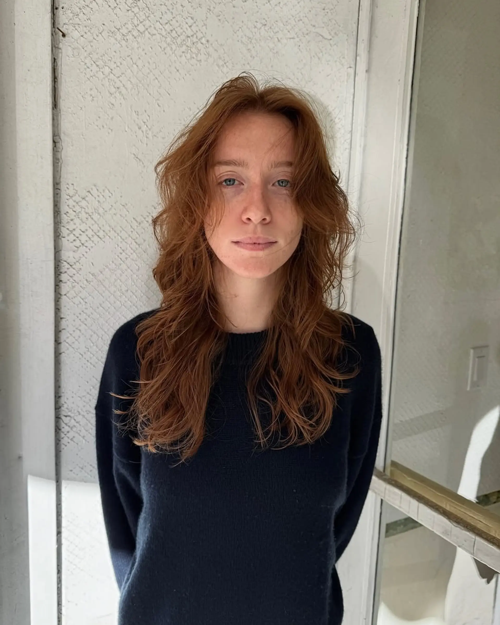 Long, wavy copper and auburn hair with natural texture and soft, face-framing layers. 1