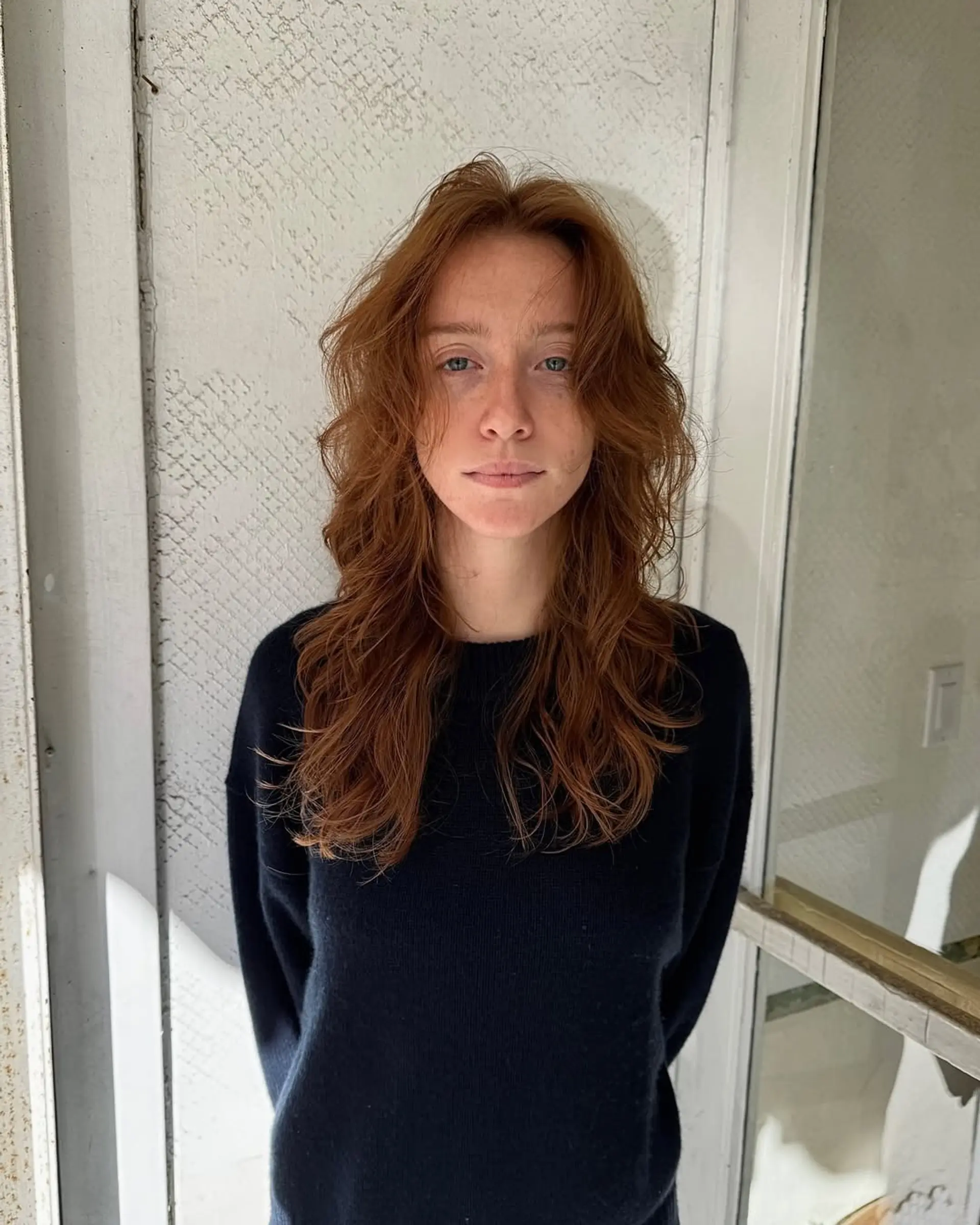 Long, wavy copper and auburn hair with natural texture and soft, face-framing layers. 2