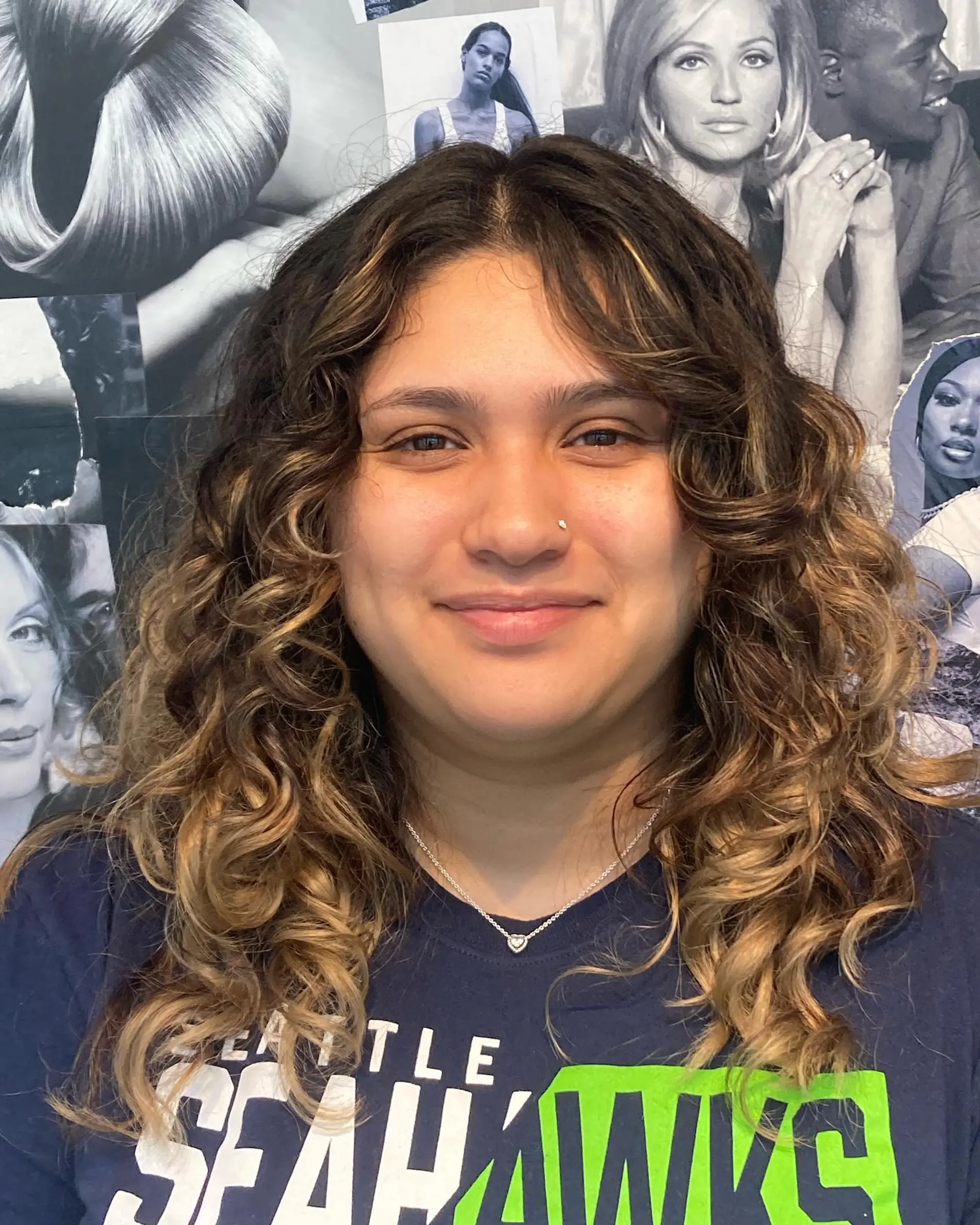 Medium-length curly hair styled with defined, voluminous ringlets and warm blonde foiliage highlights. 1