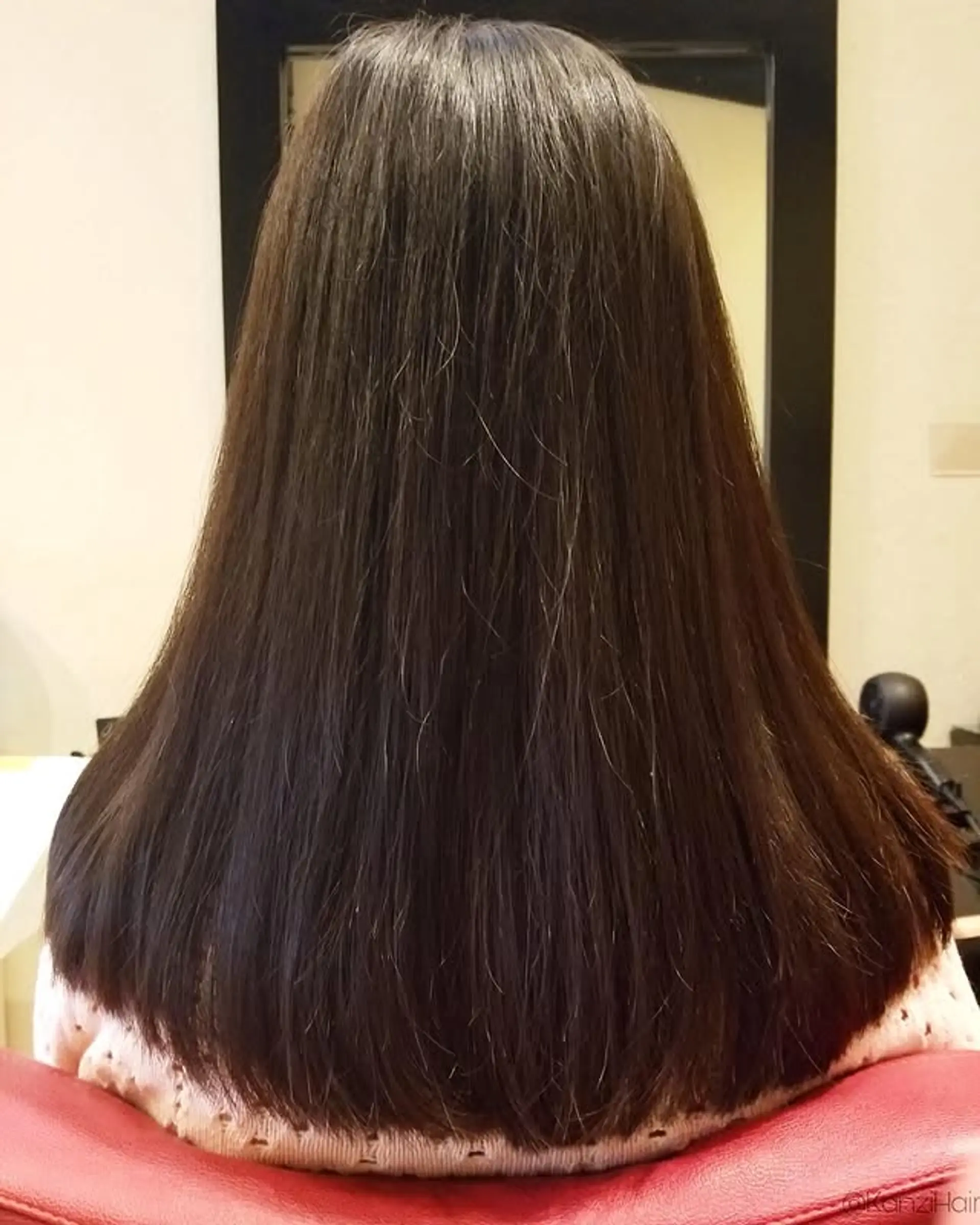A polished and sleek long straight haircut characterized by a sharp, blunt finish at the ends, creating a full and even silhouette. 1