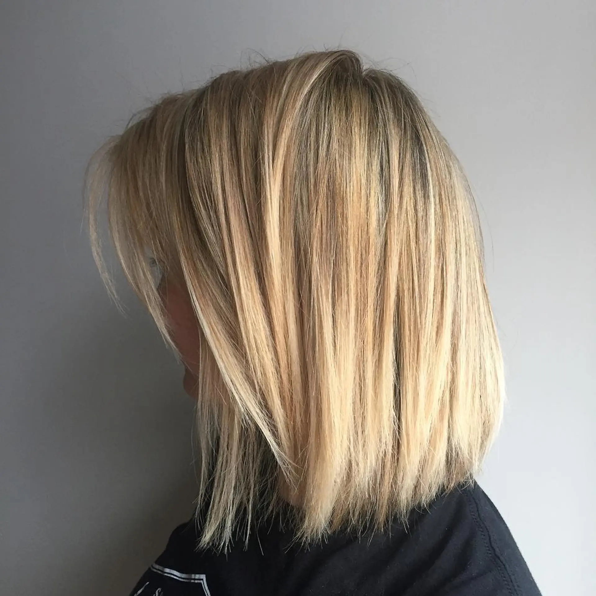 A textured and layered bob with blunt ends that offers a modern and manageable hairstyle. 1