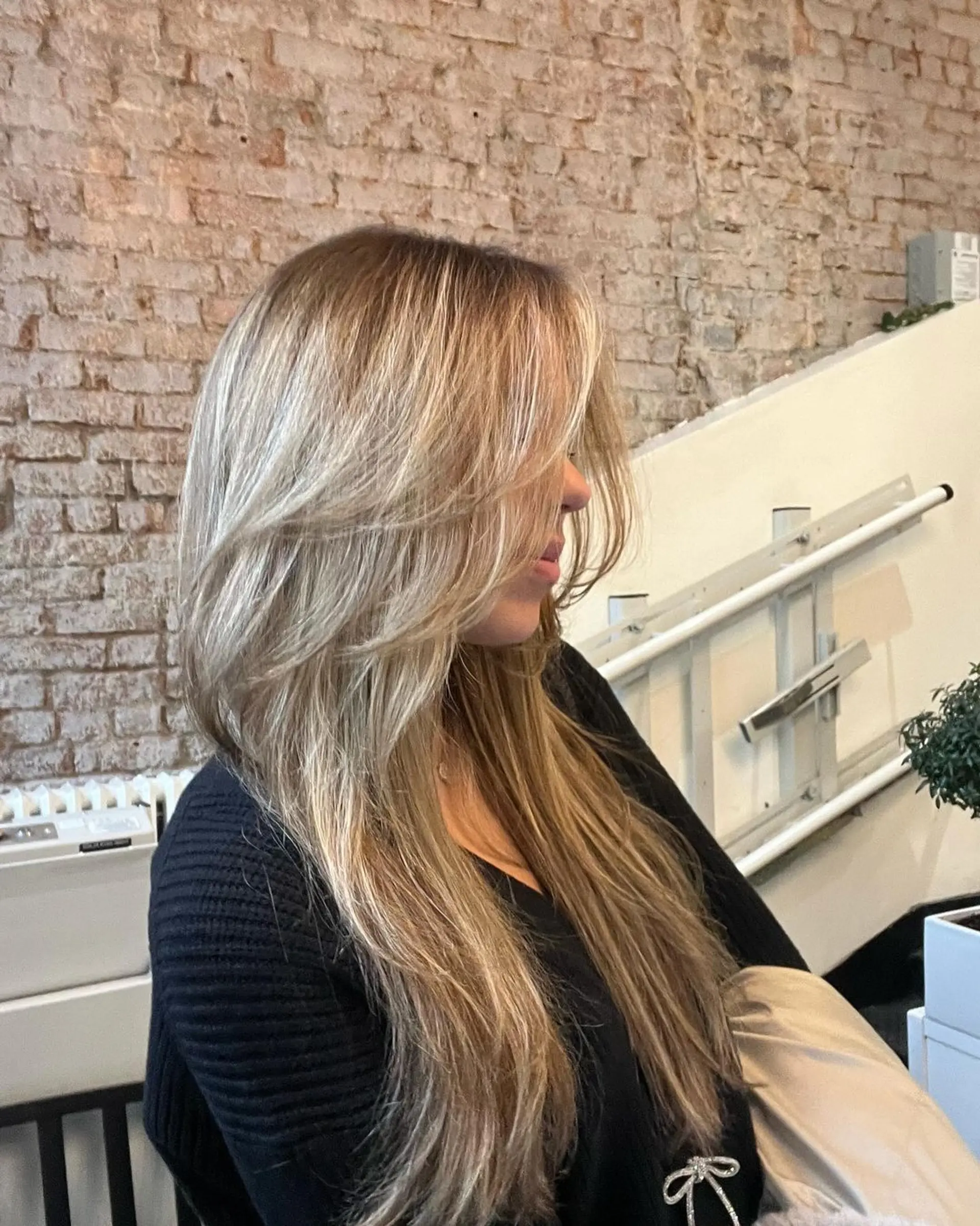 Very long, straight blonde hair with subtle honey blonde highlights, styled in layers with a side part, featuring a natural gloss. 1