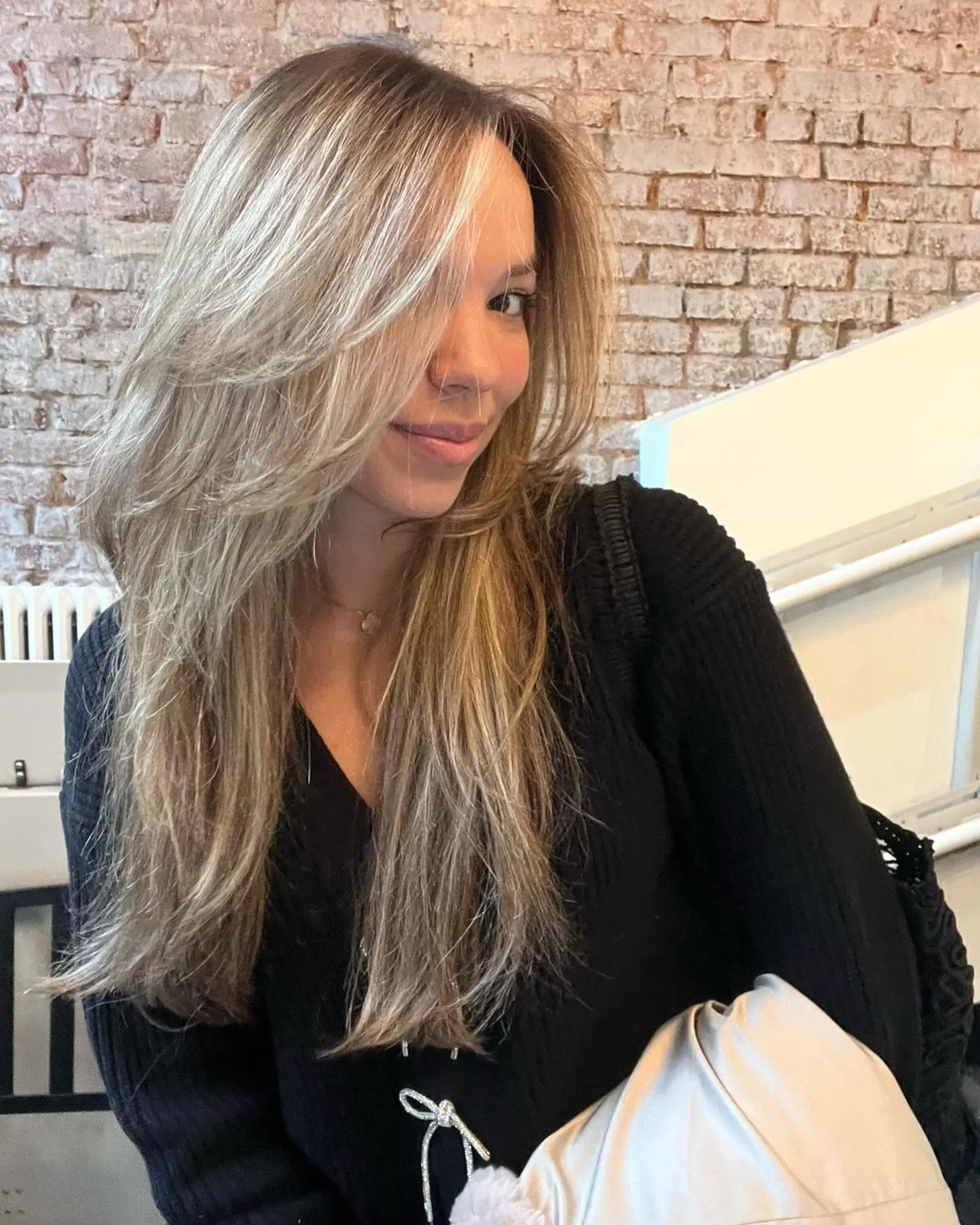 Very long, straight blonde hair with subtle honey blonde highlights, styled in layers with a side part, featuring a natural gloss. 2