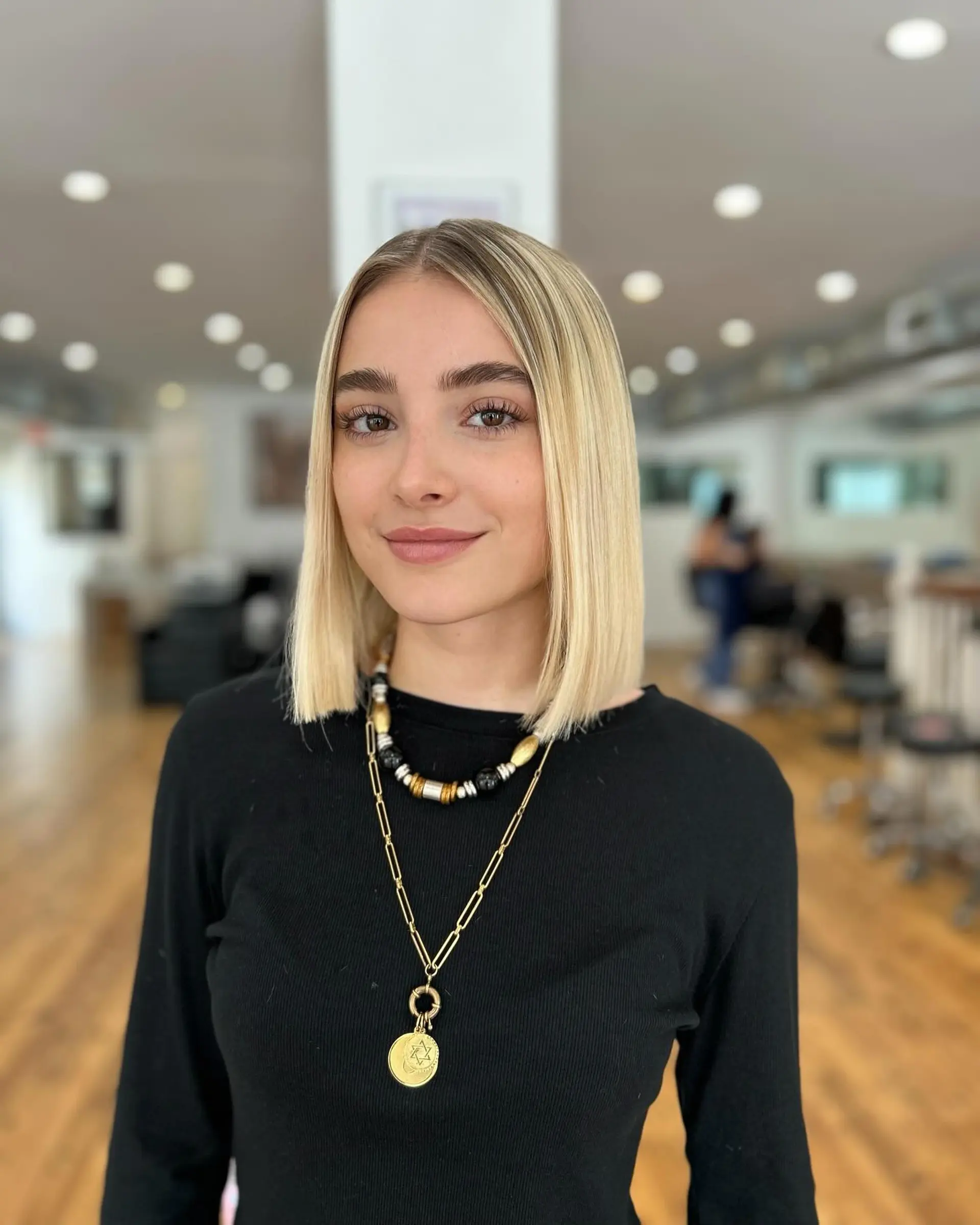 A sleek, straight blunt bob with shadow roots. 1