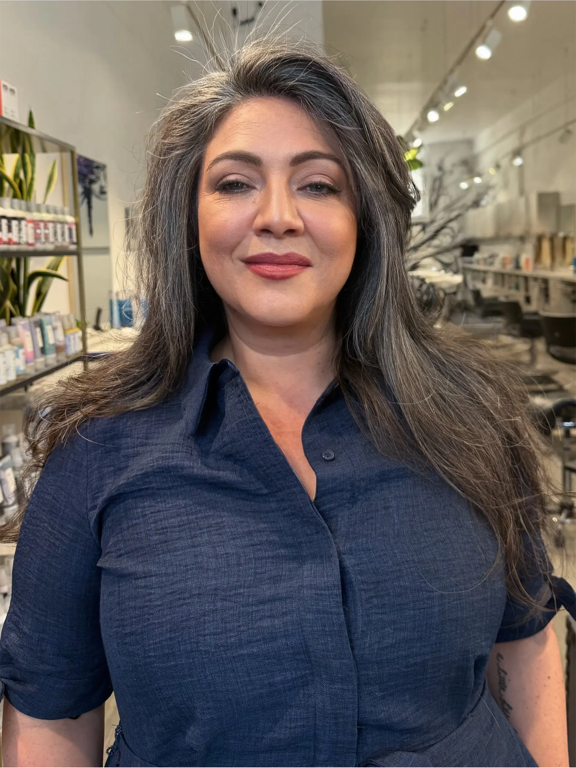 Long razor-cut layers with soft, feathery ends and natural volume, styled smooth. 1