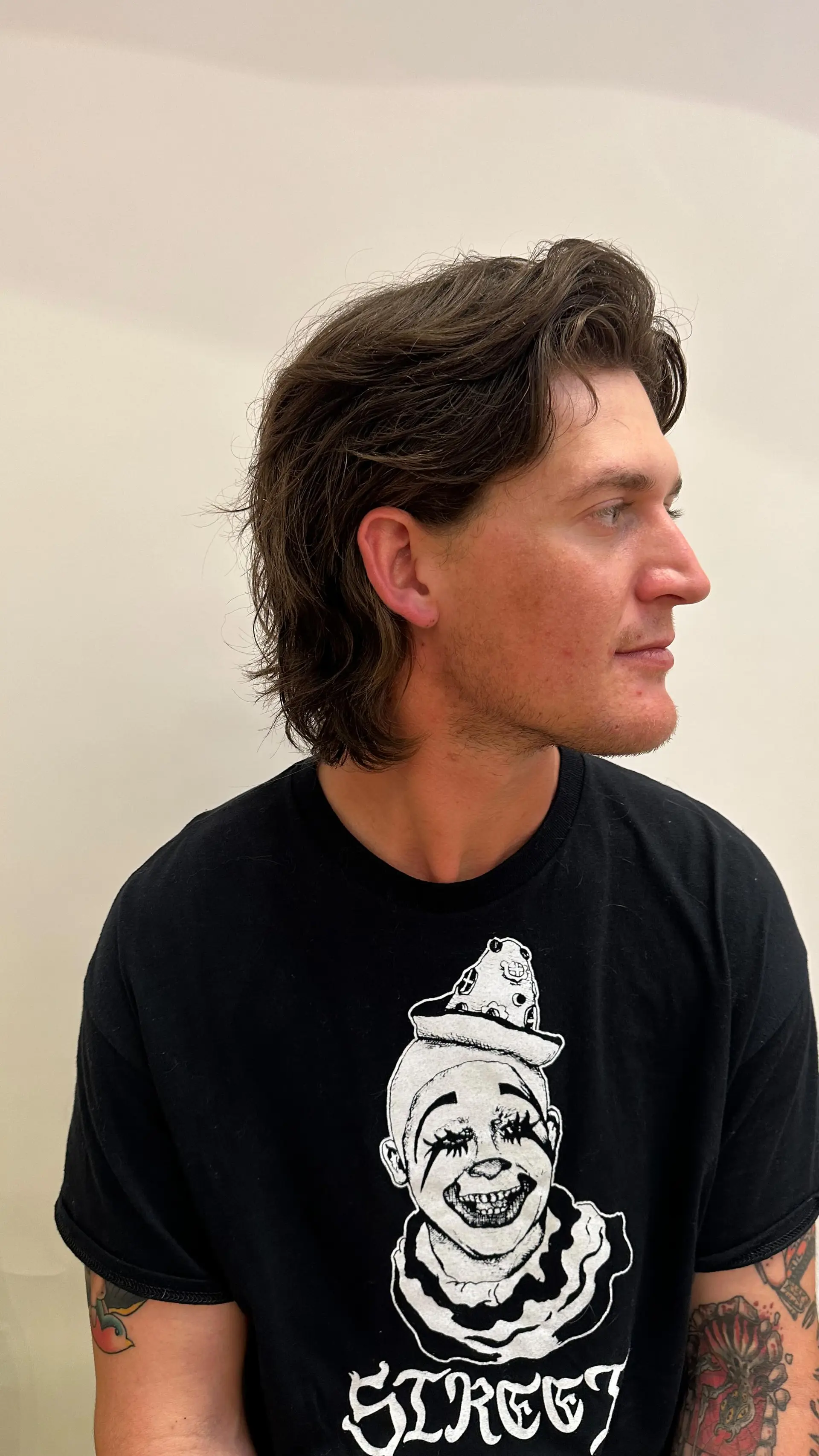 A layered, medium-short wavy haircut with volume and texture swept back away from the face. 1