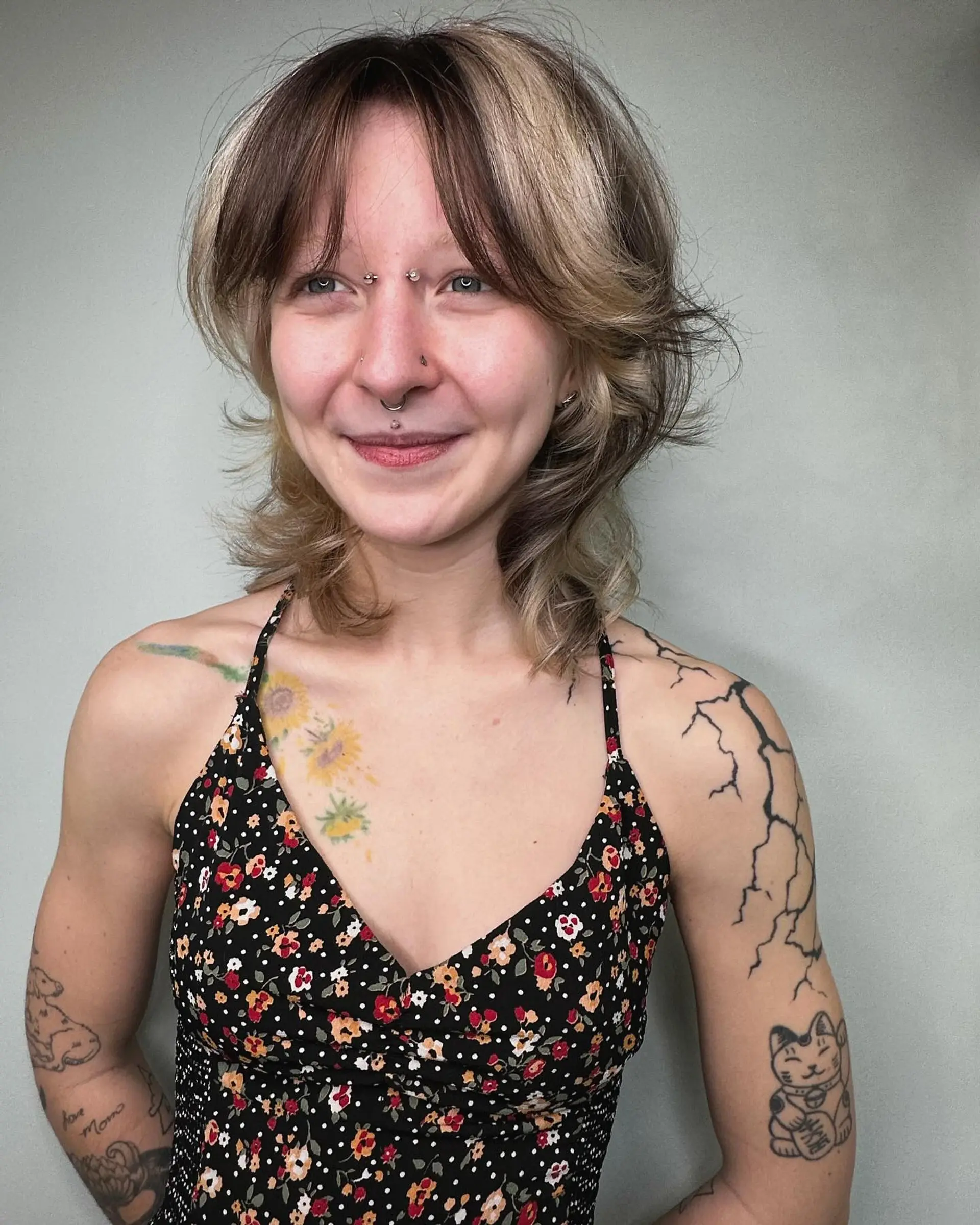 A textured shaggy mullet cut featuring contrasting blonde block panels and soft brunette curtain bangs. 1