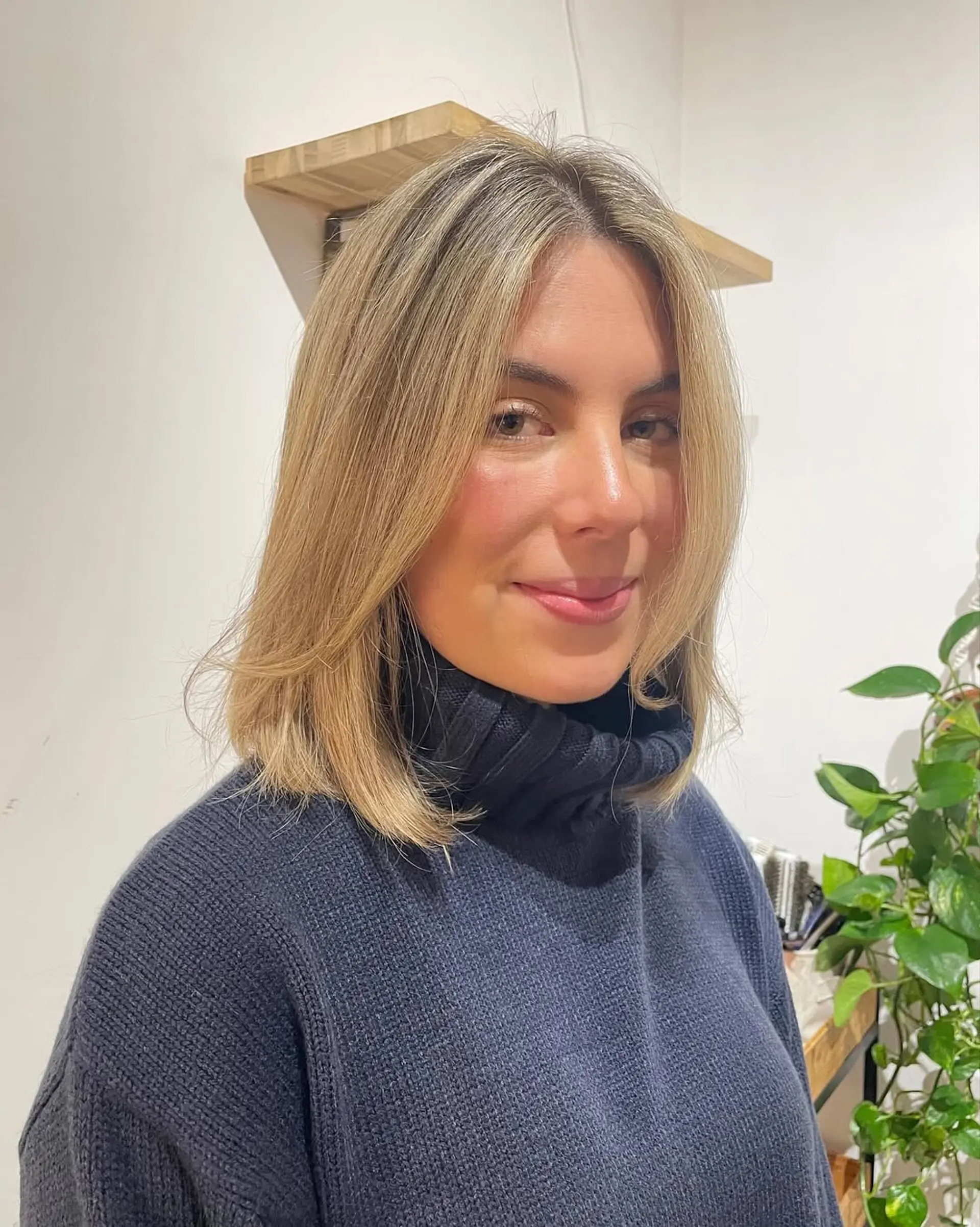 A medium-length blonde lob with subtle beachy waves and face-framing layers. 1