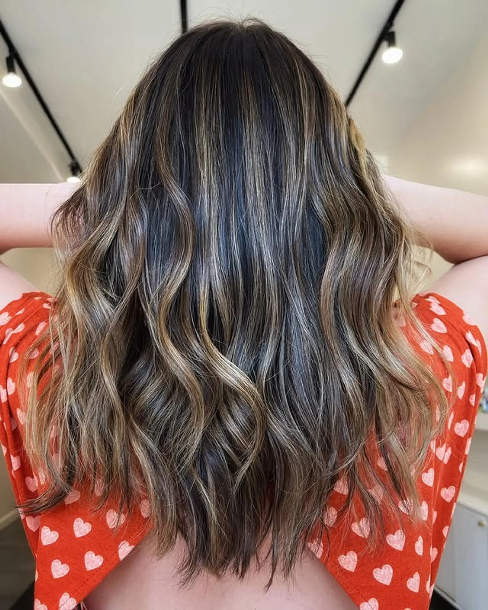 Bronde balayage with soft waves, blending brown and ash blonde tones. 1